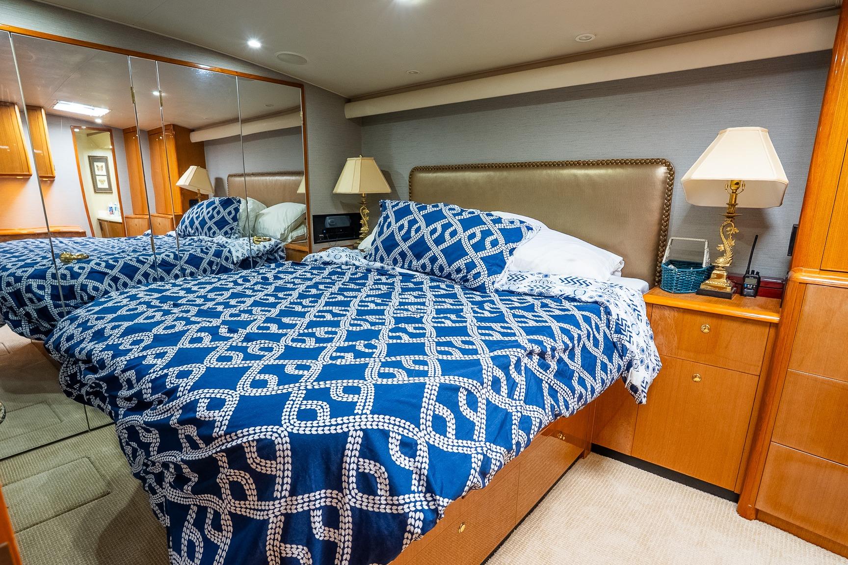 Luxurious bedroom interior on 2002 Viking 61 Enclosed Bridge yacht with elegant decor.