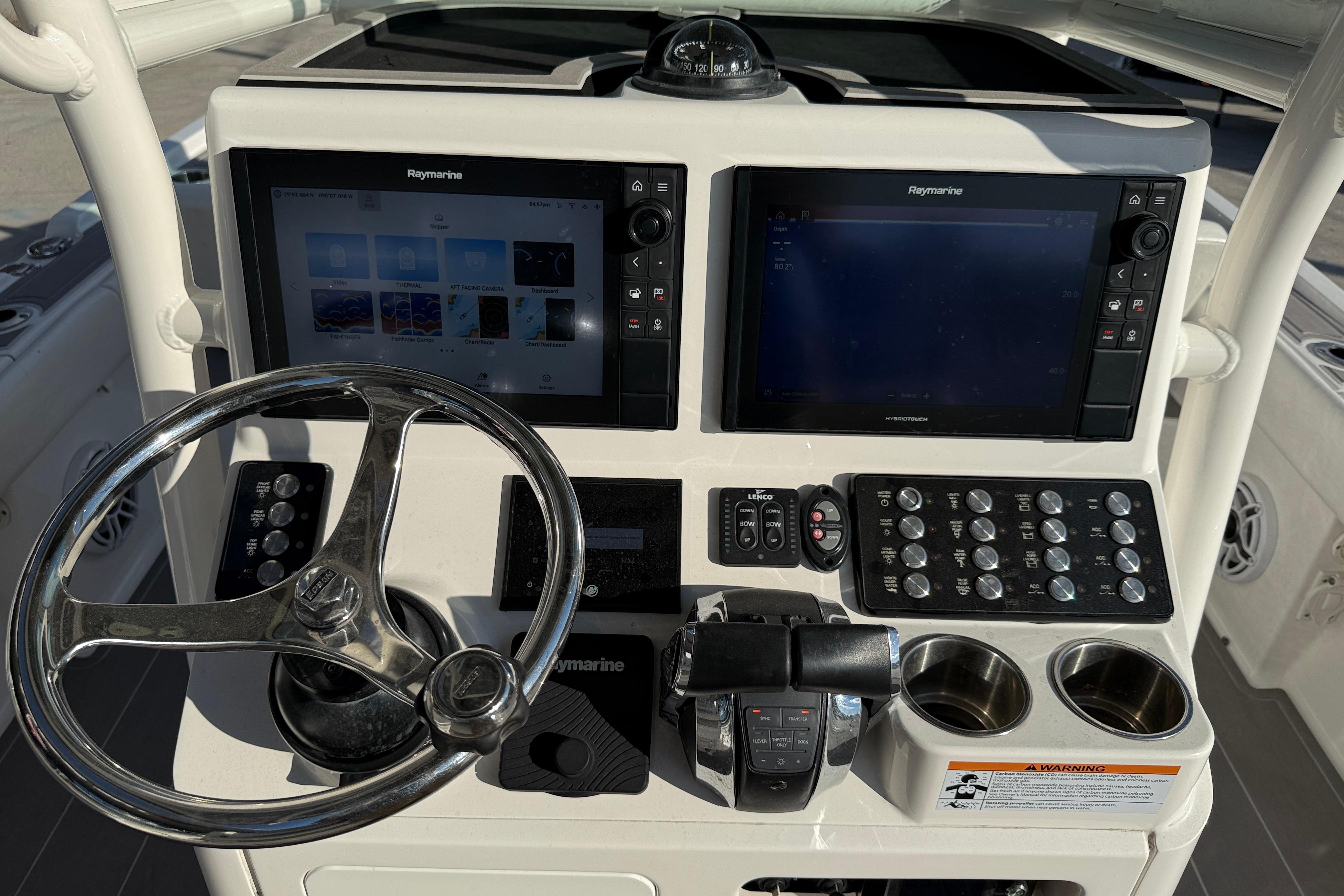 2022 Caymas 28 HB Twin boat dashboard with dual Raymarine displays and controls.