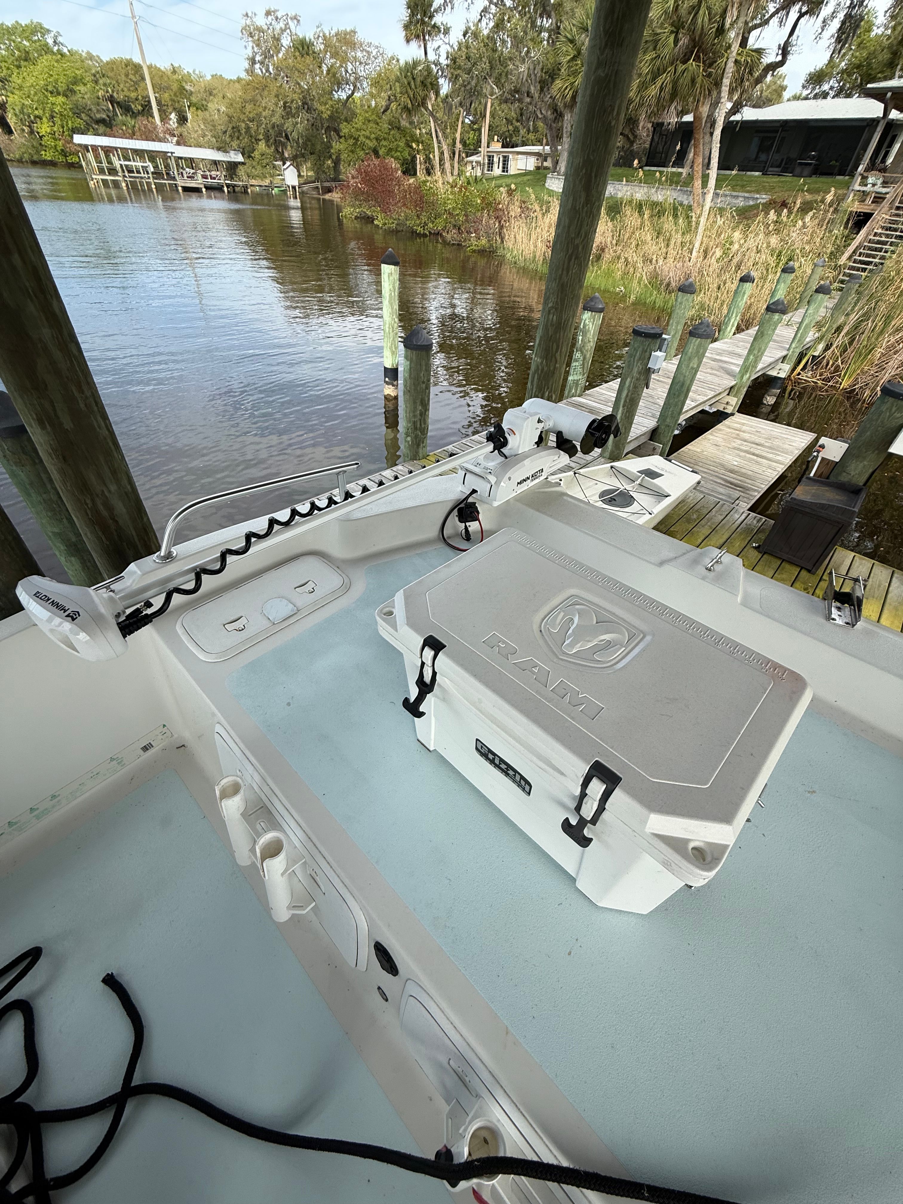 A boat docked at a serene pier with a RAM cooler on board.