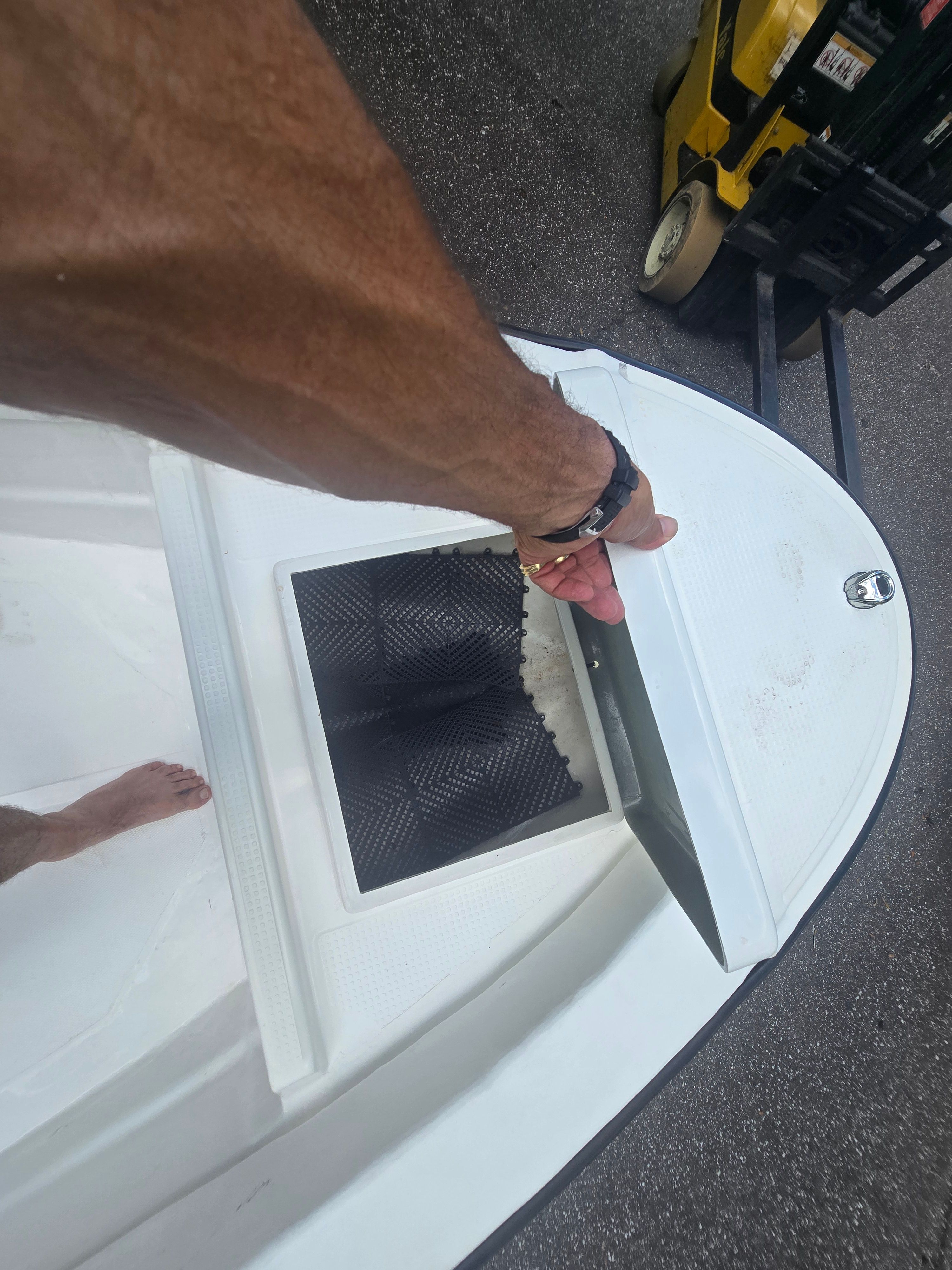 Person opening compartment on Panga Eduardono boat, 2022 model.