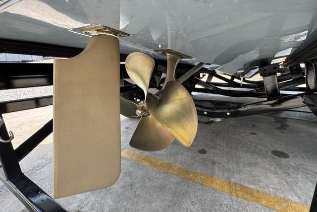 Propeller and rudder of 2026 MasterCraft XStar 25 boat on trailer.