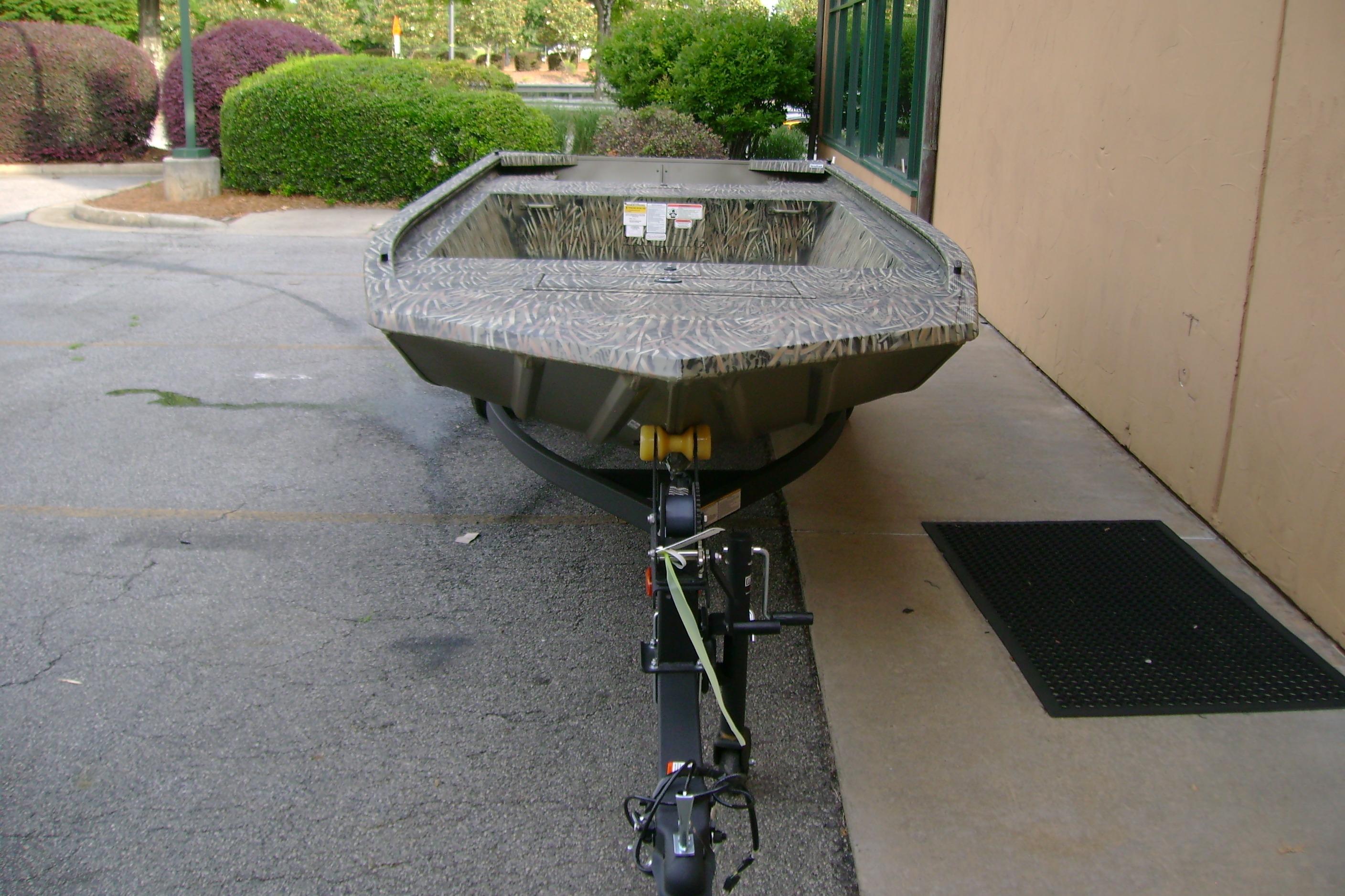 2026 Tracker Grizzly 1648 Utility boat parked outdoors on a trailer.