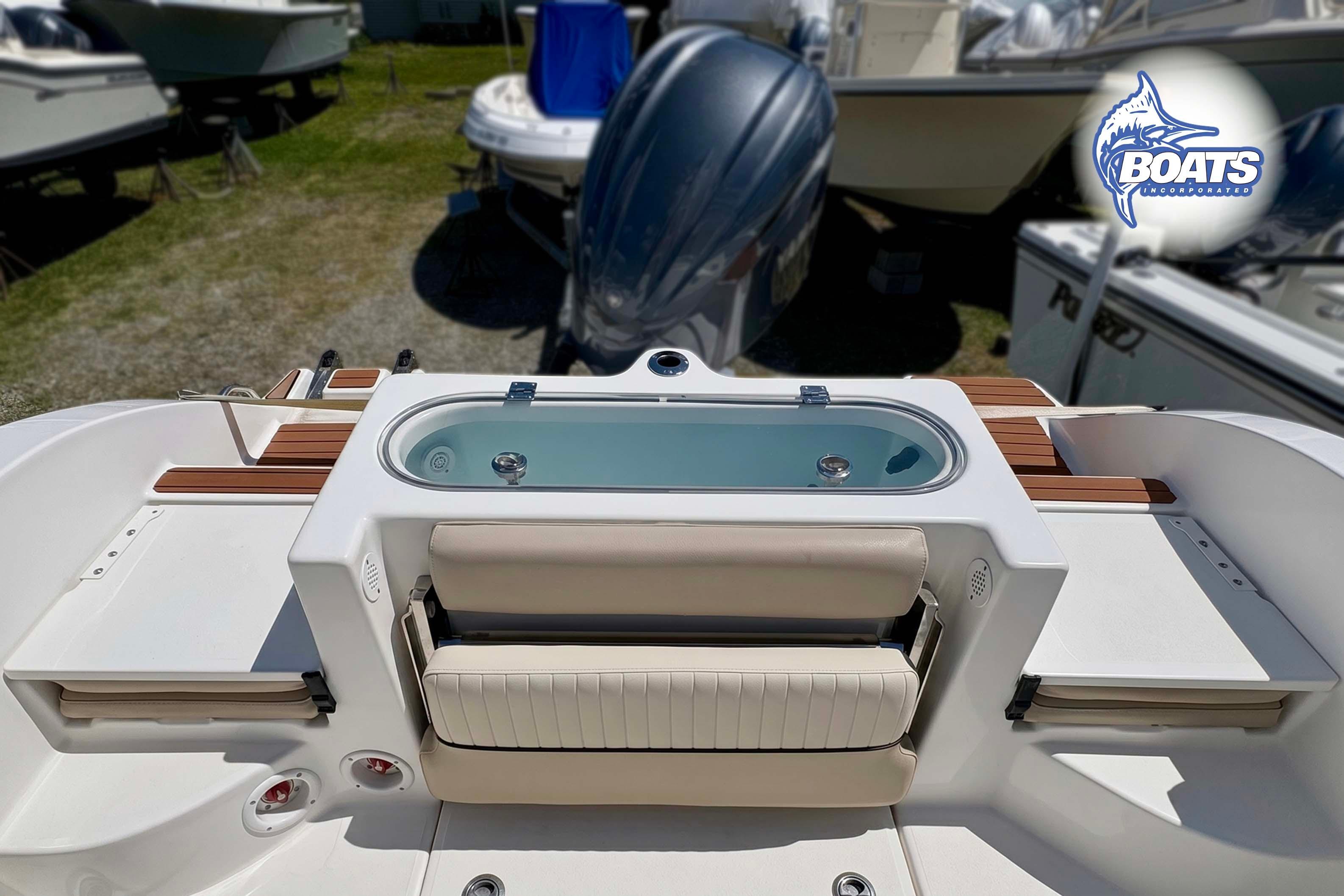 2015 Sea Fox 266 Commander boat deck with seating and storage compartments.