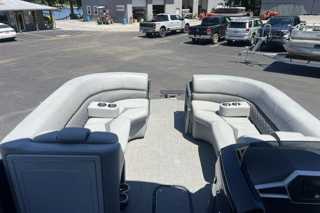 2024 Manitou 25 LX SRW pontoon boat interior with gray seating and cup holders.