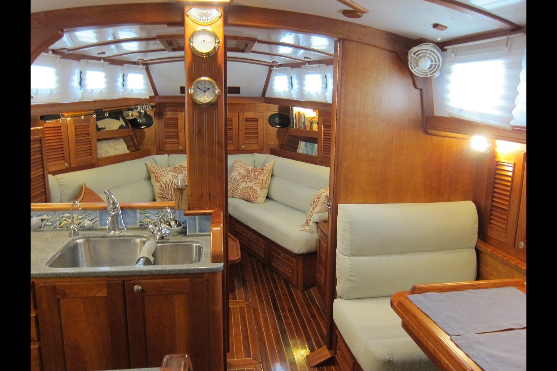 Luxurious 2008 Gozzard 41B yacht interior with elegant wood finish and cozy seating area.