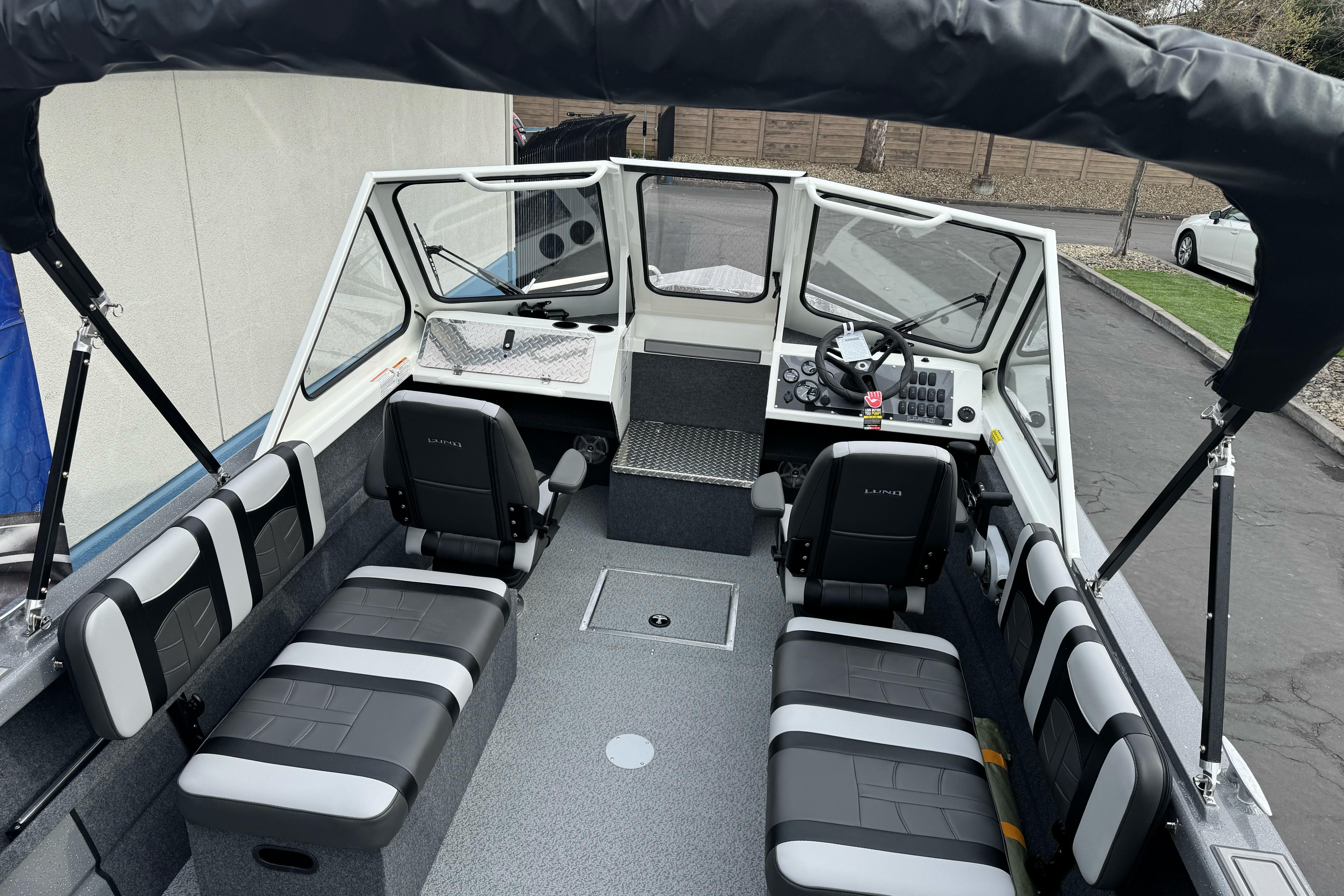 2026 Lund 185 Heavy Gauge boat interior with seating and steering console.