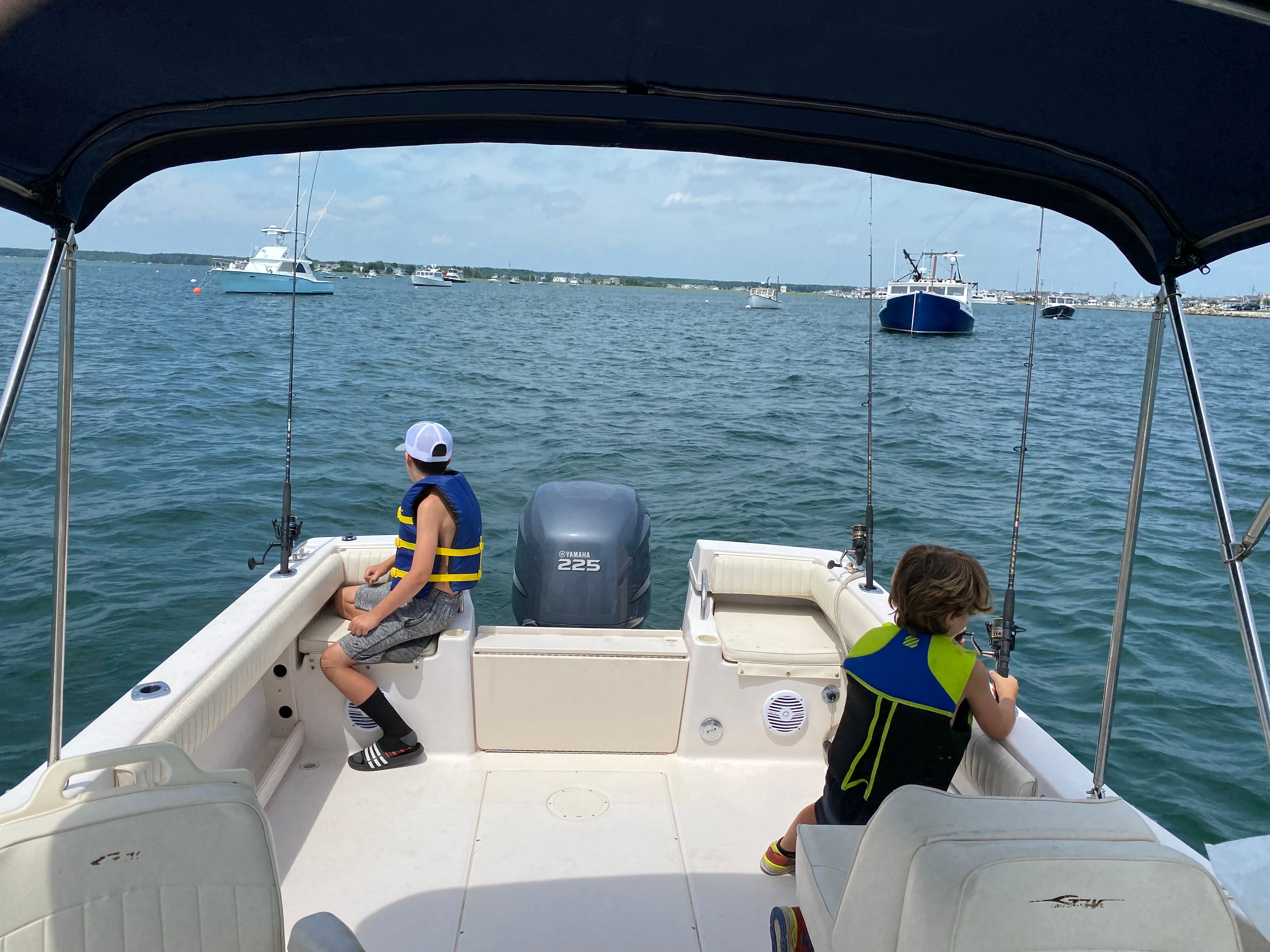 Children fishing on a 2002 Grady-White Tournament 223 boat.