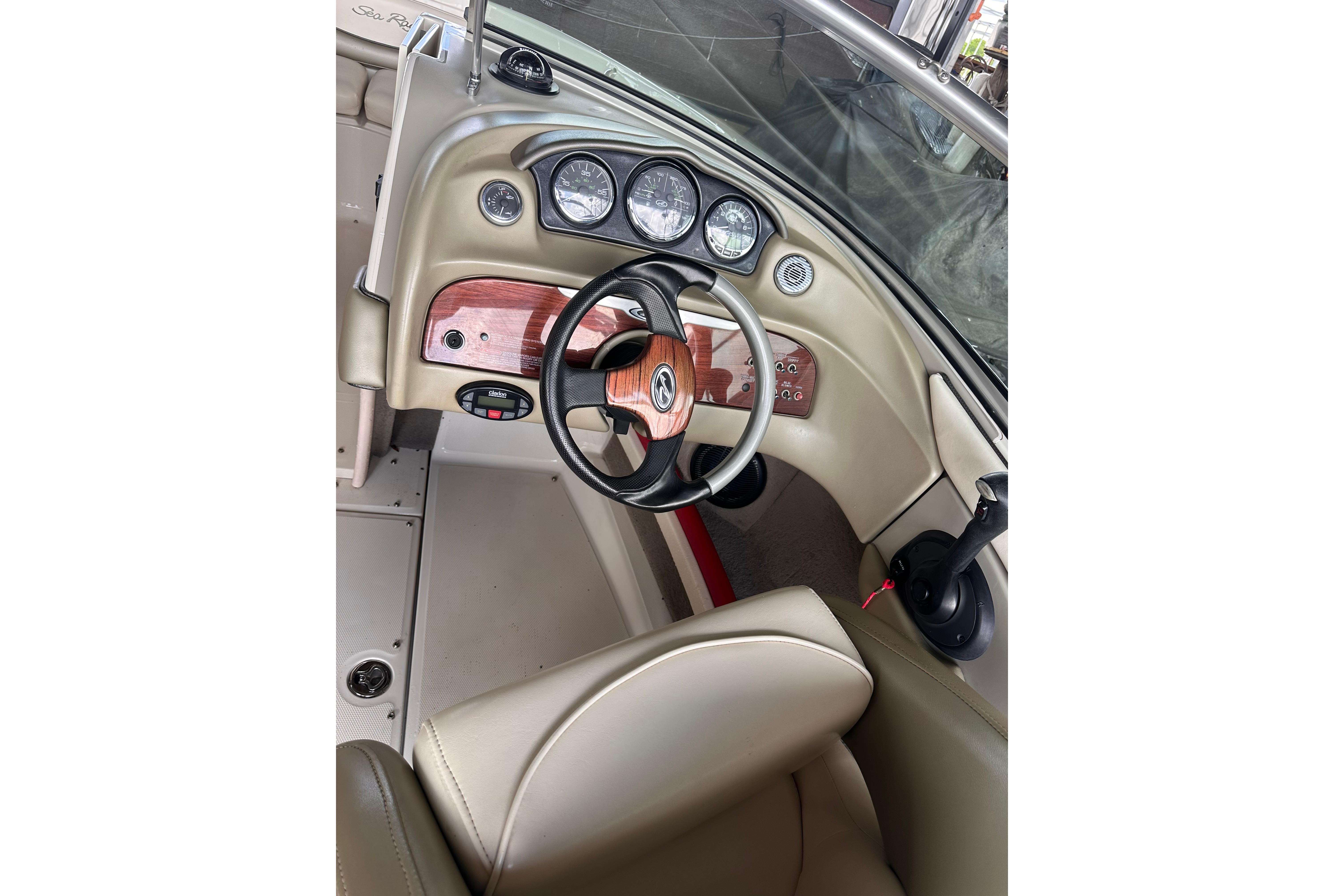 2005 Sea Ray 200 Select boat dashboard with steering wheel and gauges.