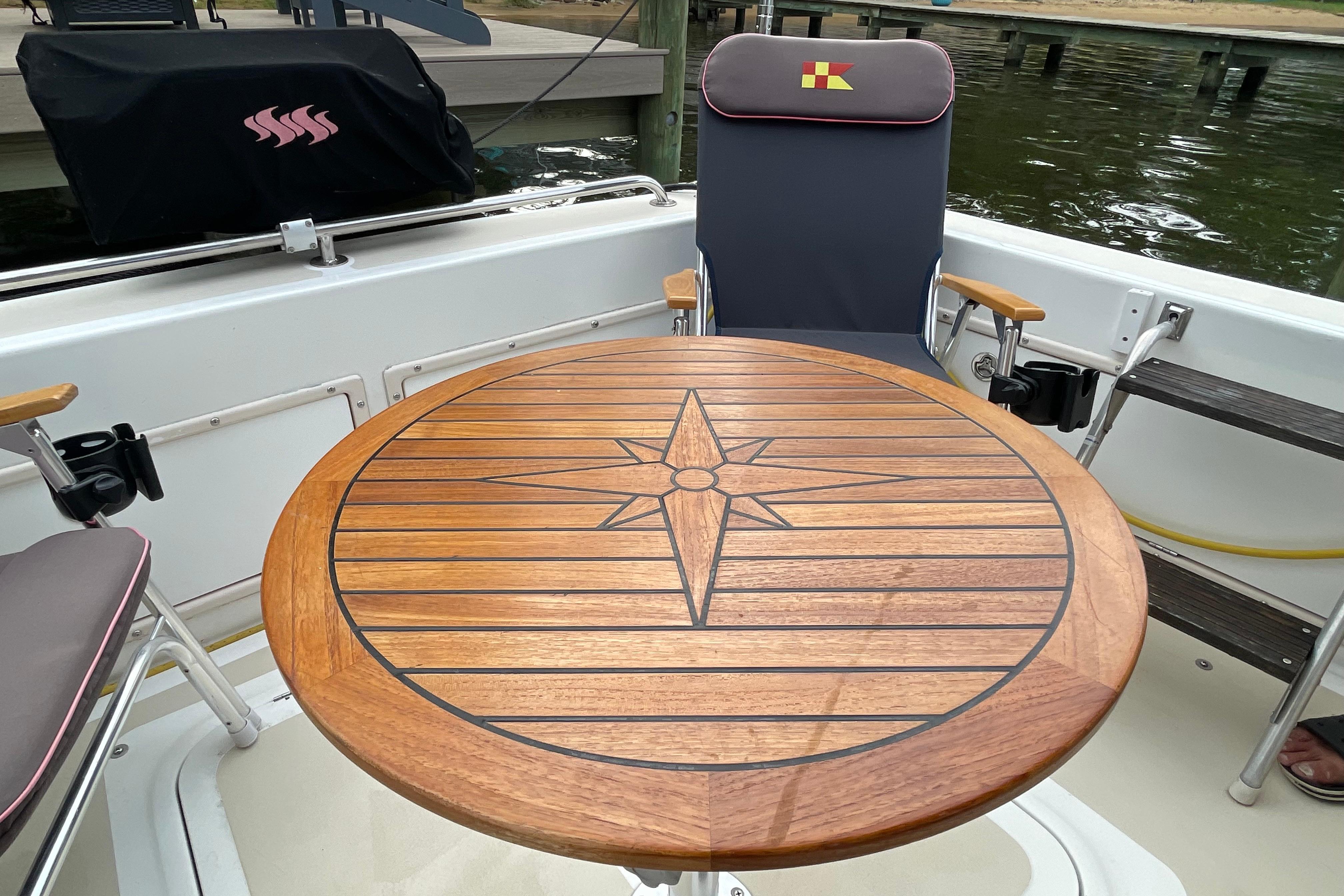 Wooden table with compass design on Fox Island Thirty Sedan Cruiser, 2005 model.