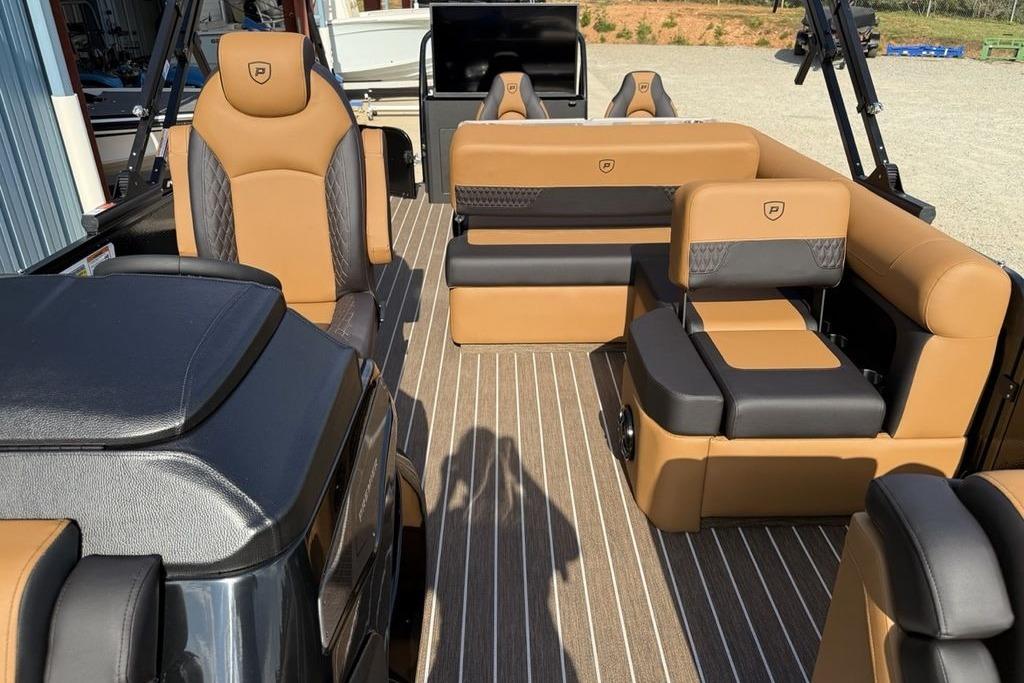 Luxurious interior of 2026 Premier 250 Solaris RS CL pontoon boat with tan and black seating.