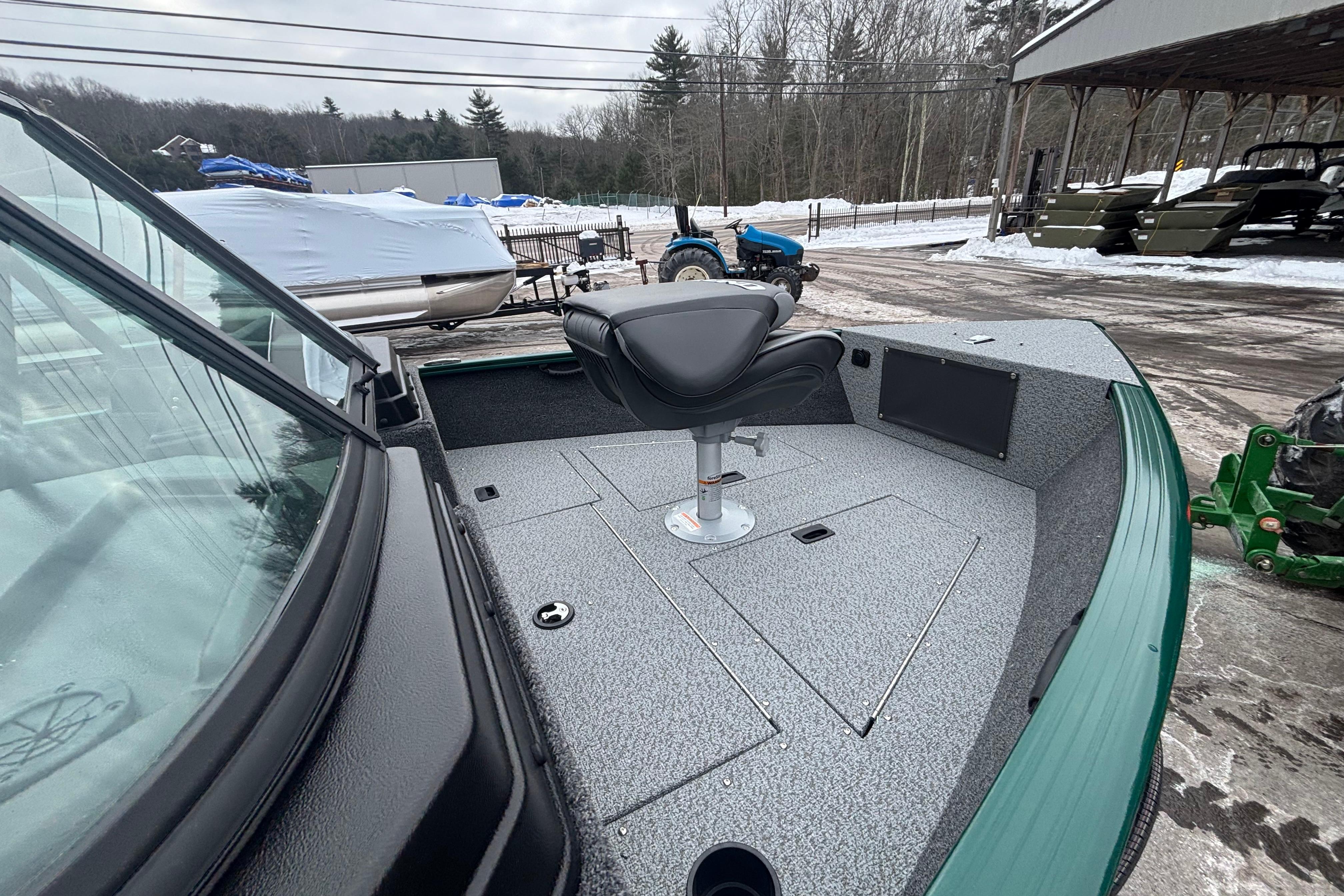2026 Lund 1650 Rebel XL Sport boat with seating, parked in snowy outdoor setting.
