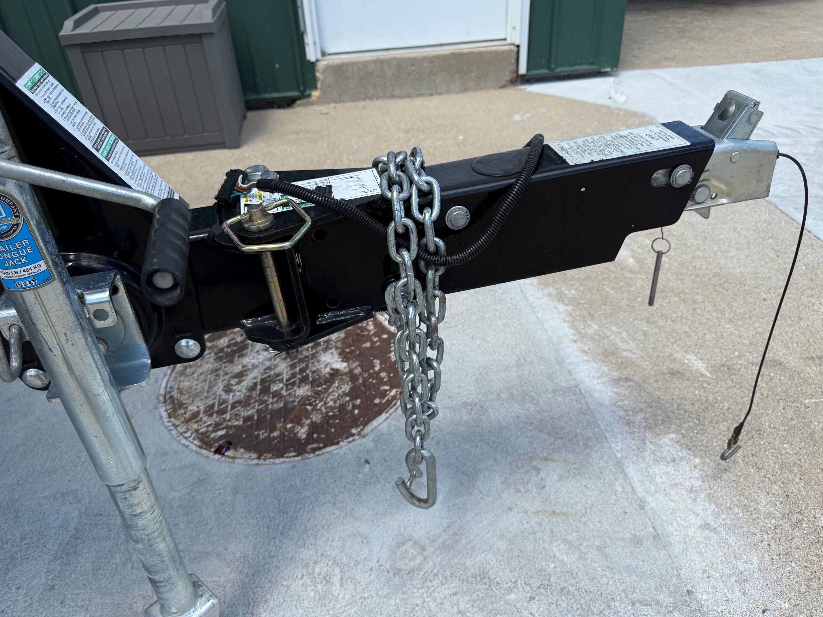 Close-up of a boat trailer with chain and safety pin.