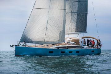 2016 Jeanneau 64 sailboat cruising on open water.