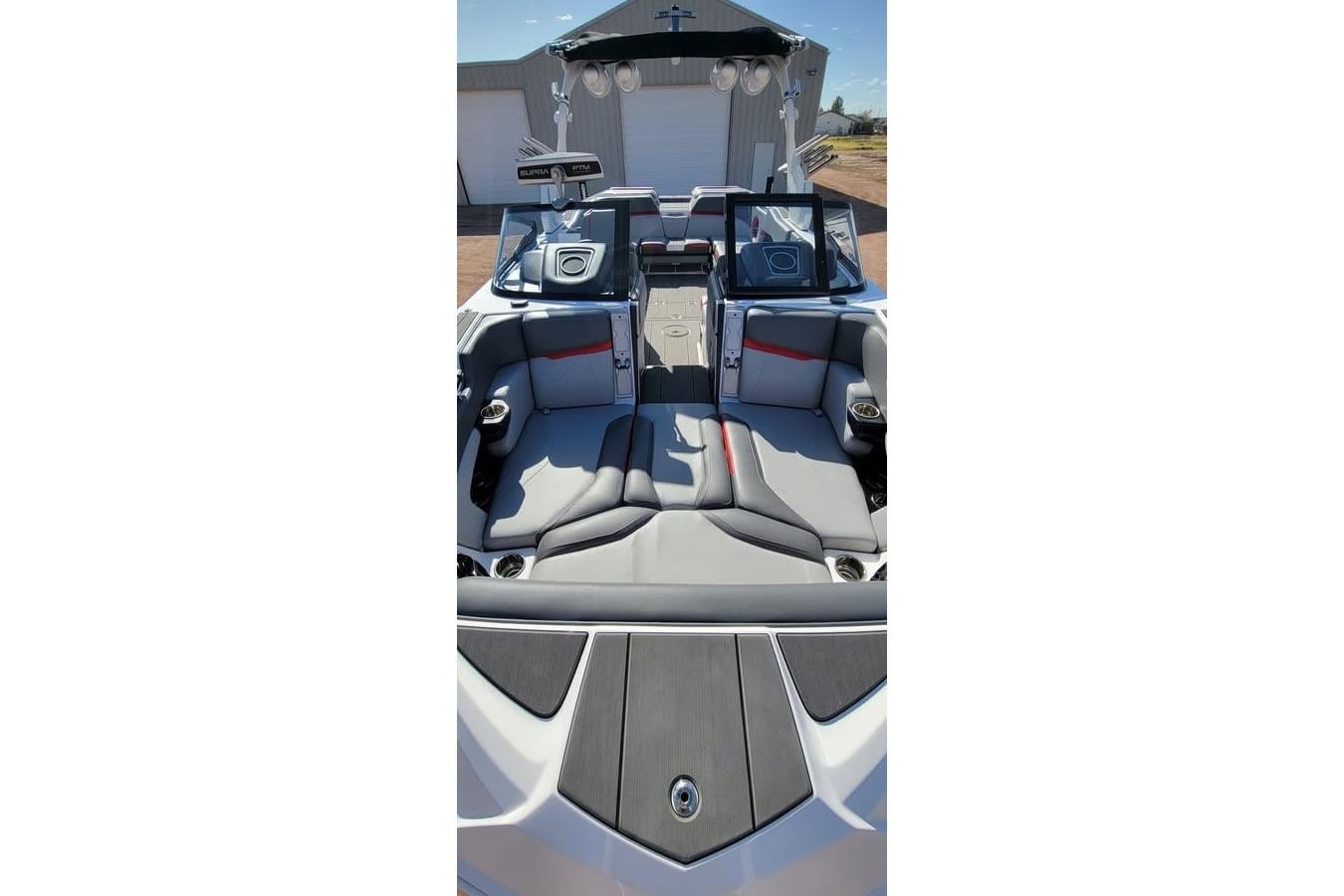 2023 Supra SE 550 boat interior with gray seating and red accents.