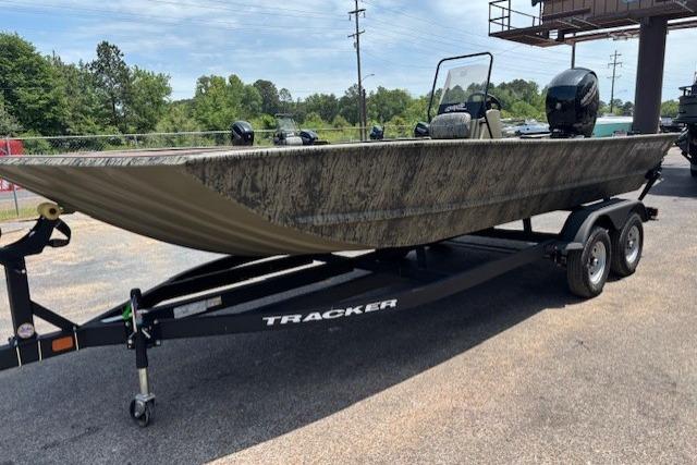 2026 Tracker Grizzly 2072 CC boat on trailer, parked outdoors.