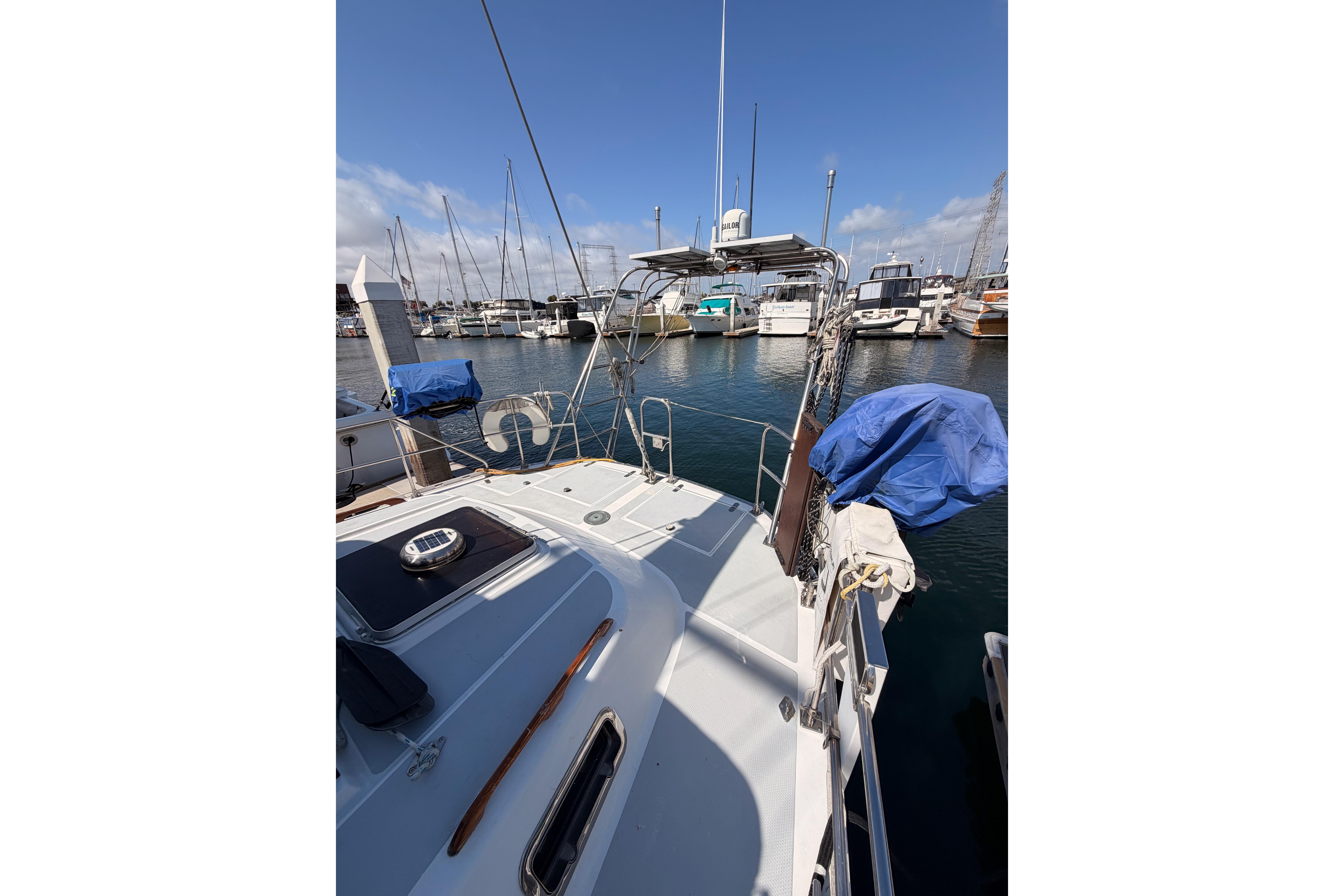 Sailboat docked in marina, Hylas 51, 1991 model, sunny day, clear sky.