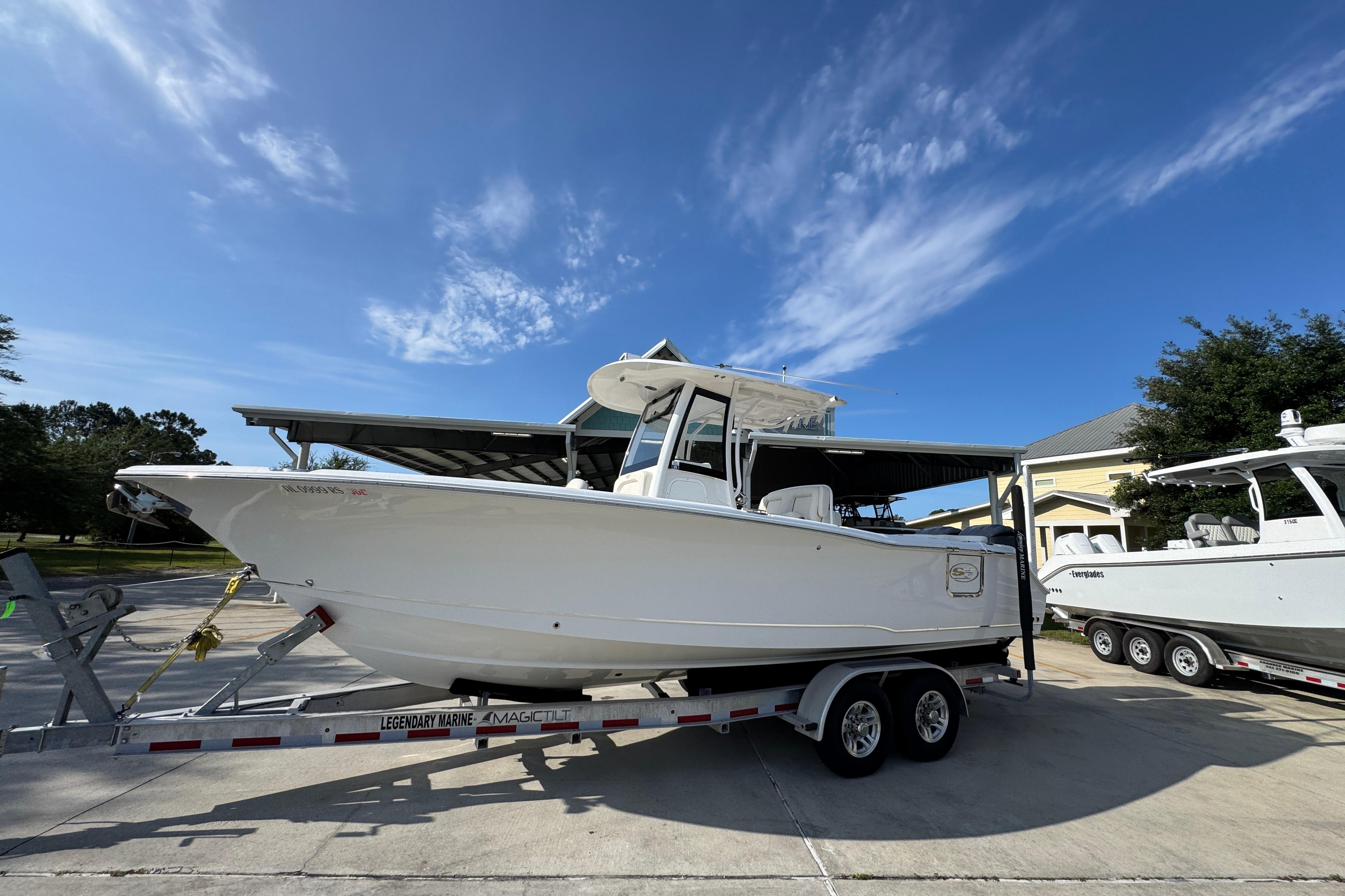 2022 Sea Hunt Ultra 275 SE boat on trailer under clear blue sky.