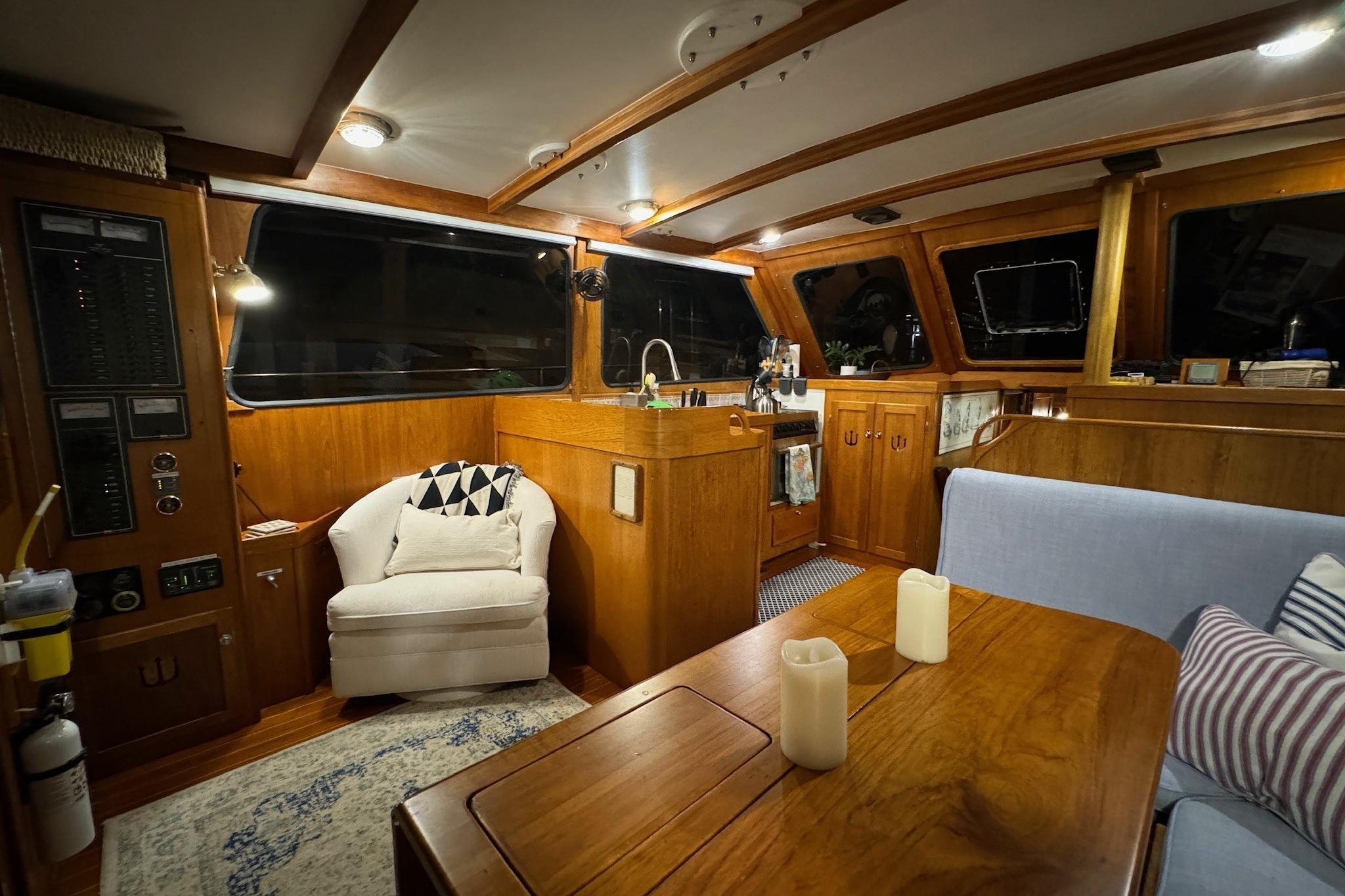 Cozy interior of 1987 Lyman-Morse Hunt 42 yacht with wooden furnishings and seating area.