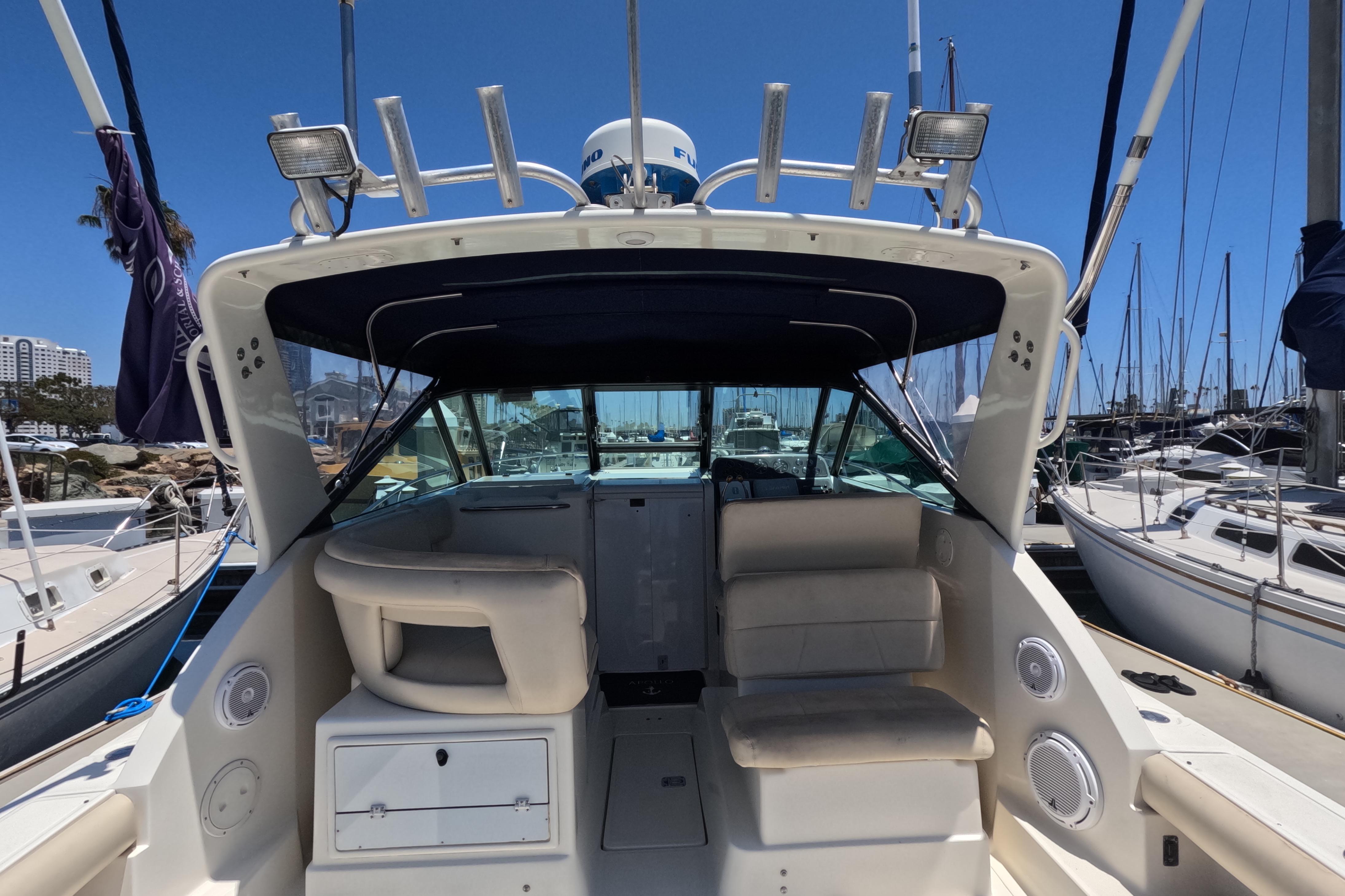 1995 Tiara Yachts 2900 Open boat interior at marina, showcasing seating and helm area.