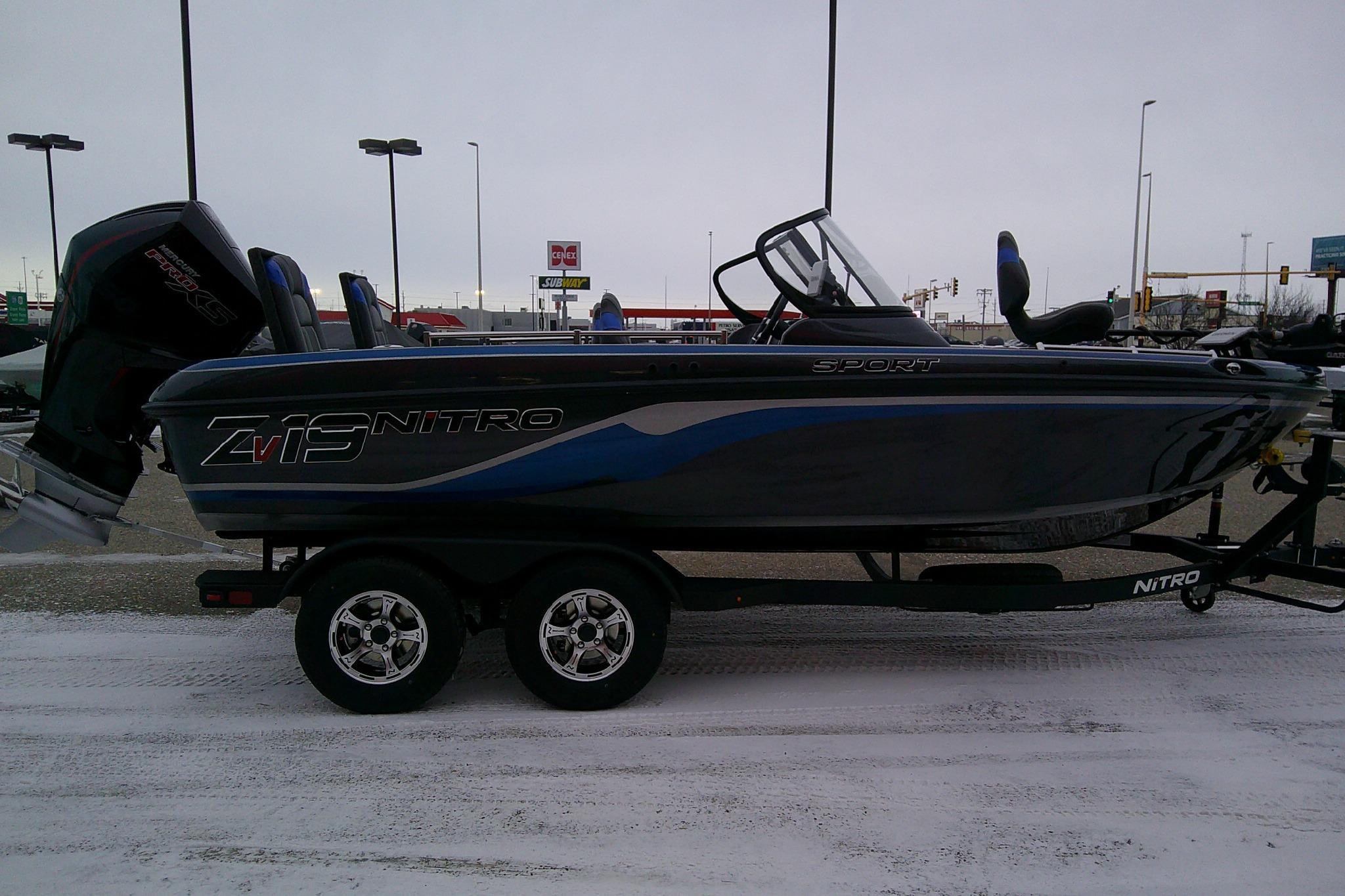 2026 Nitro ZV19 Sport Pro boat on trailer in snowy parking lot.