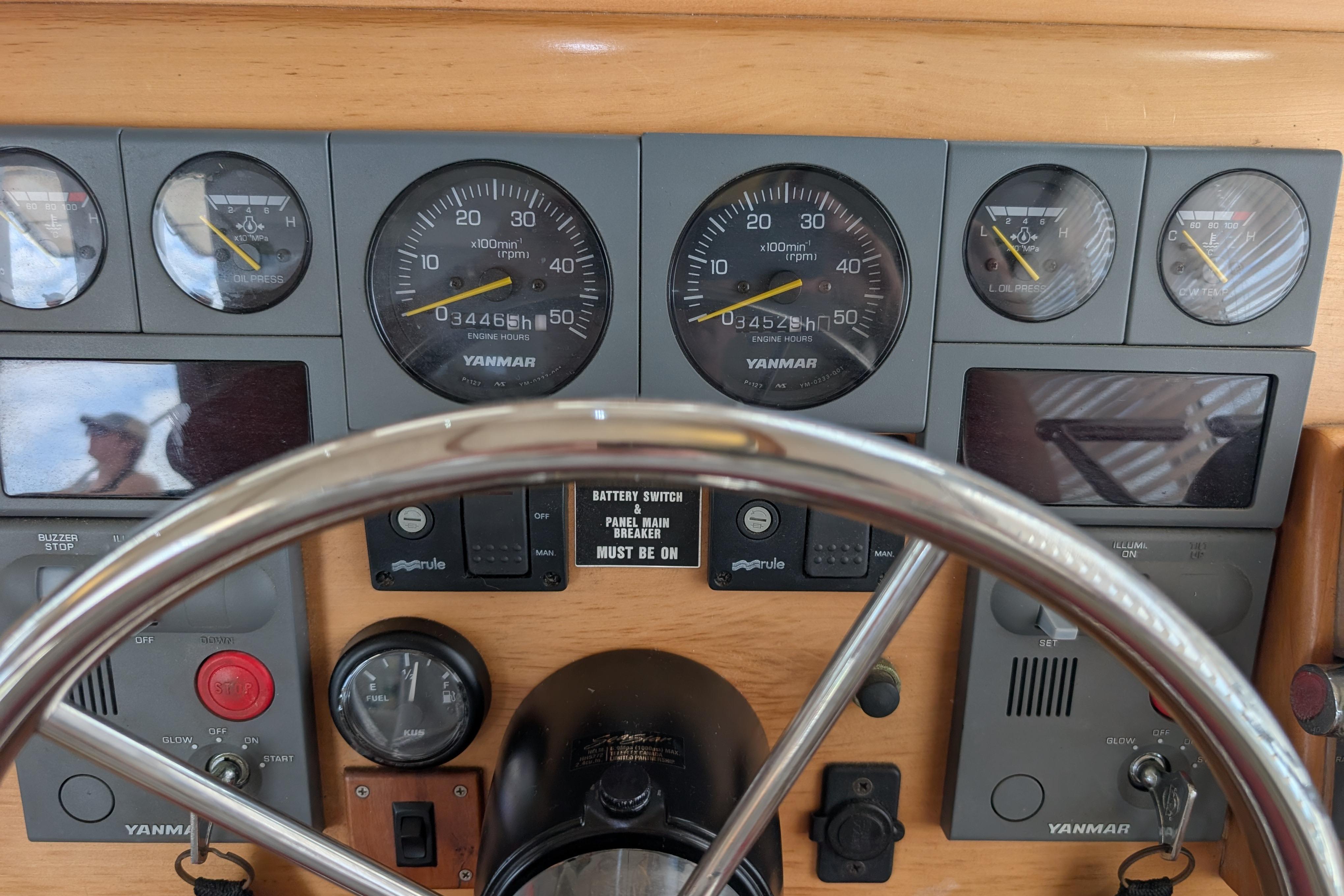 Dashboard of a 2004 PDQ 34 Powercat with Yanmar engine gauges and controls.