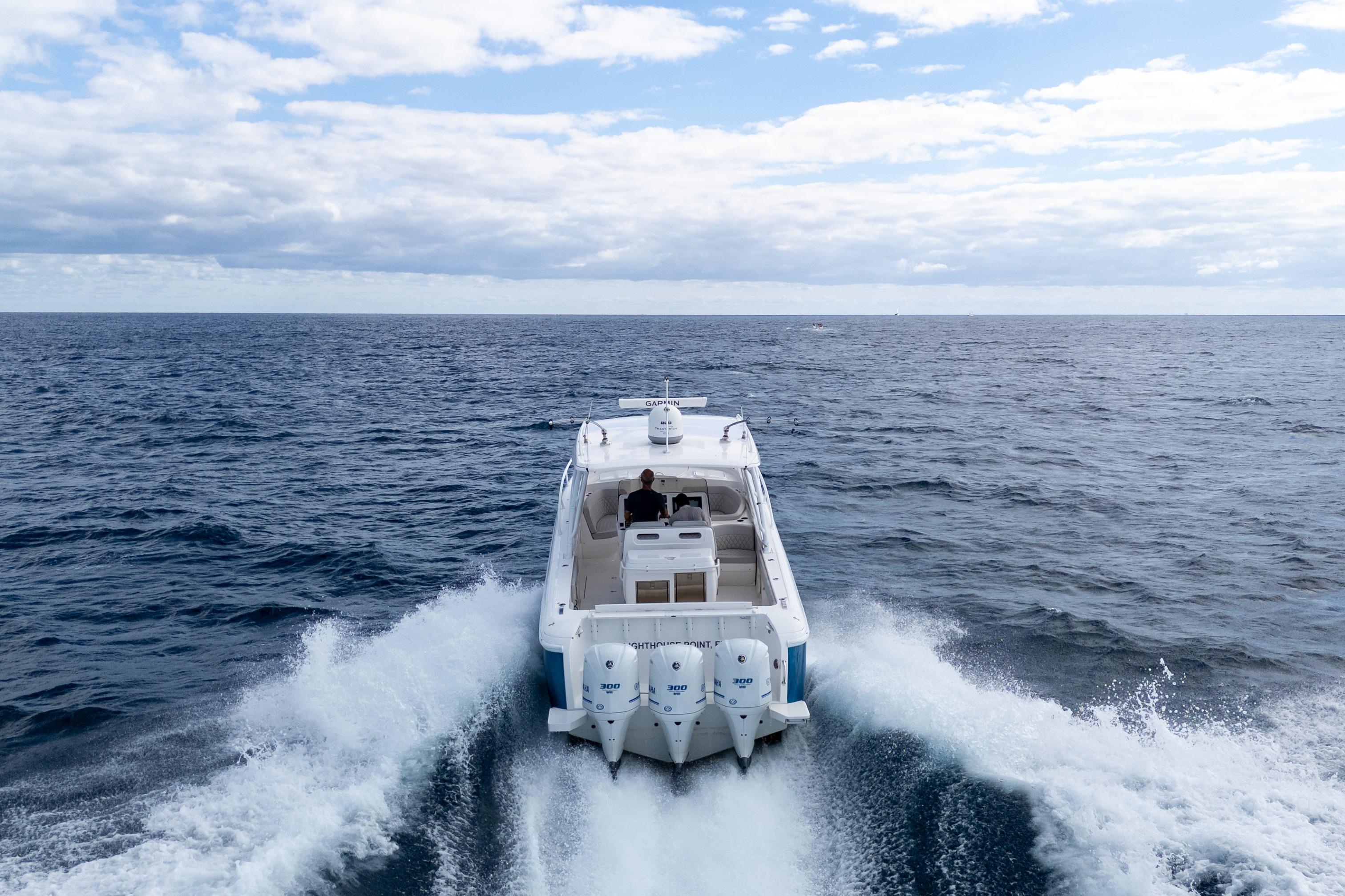 2019 Intrepid 407 Cuddy cruising on open ocean under cloudy sky.