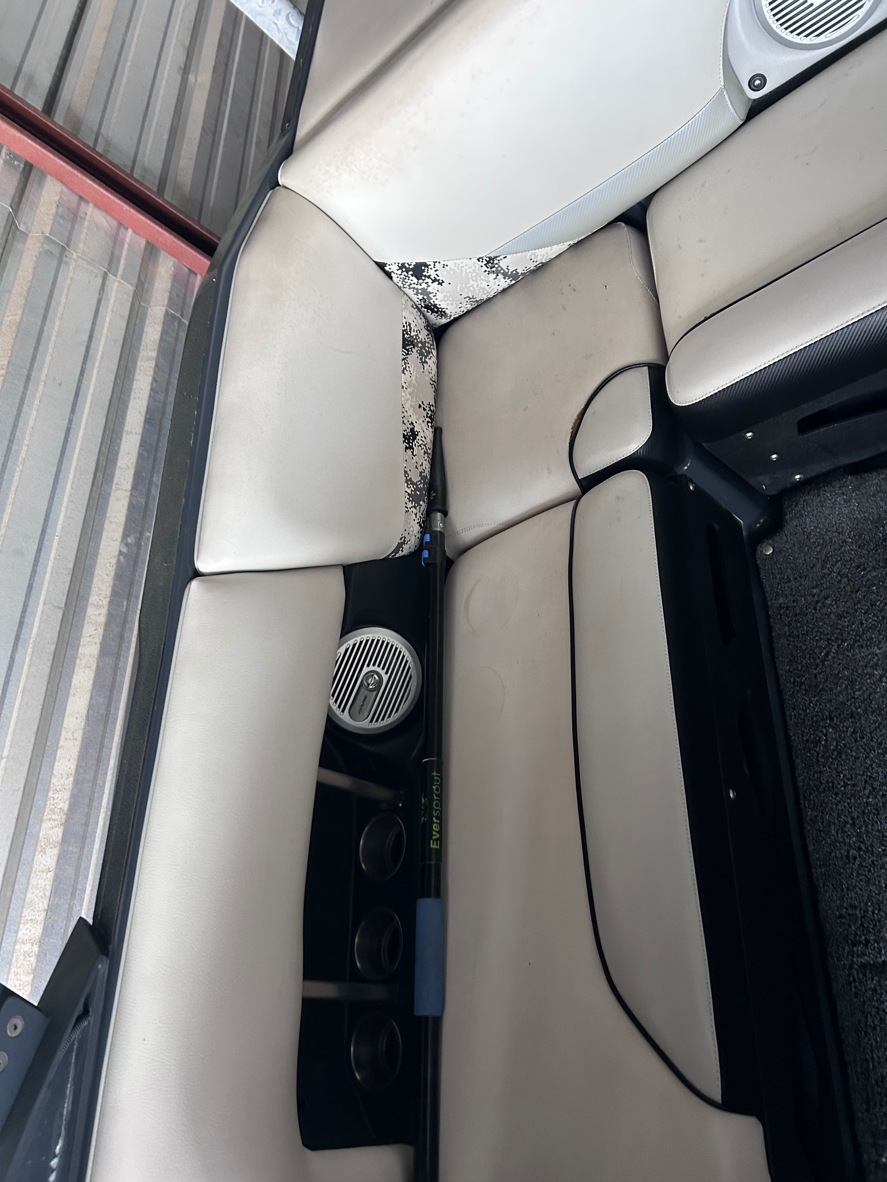 Interior of a 2013 Axis A22 with speakers and seat cushions.