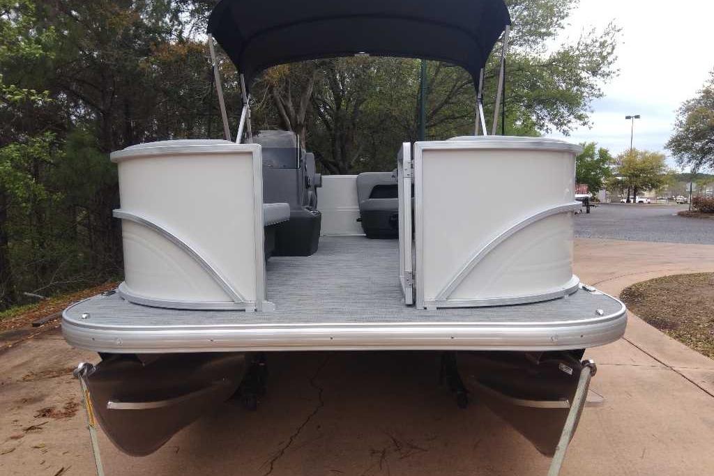 2026 Sun Tracker Party Barge 16 DLX pontoon boat on a driveway.