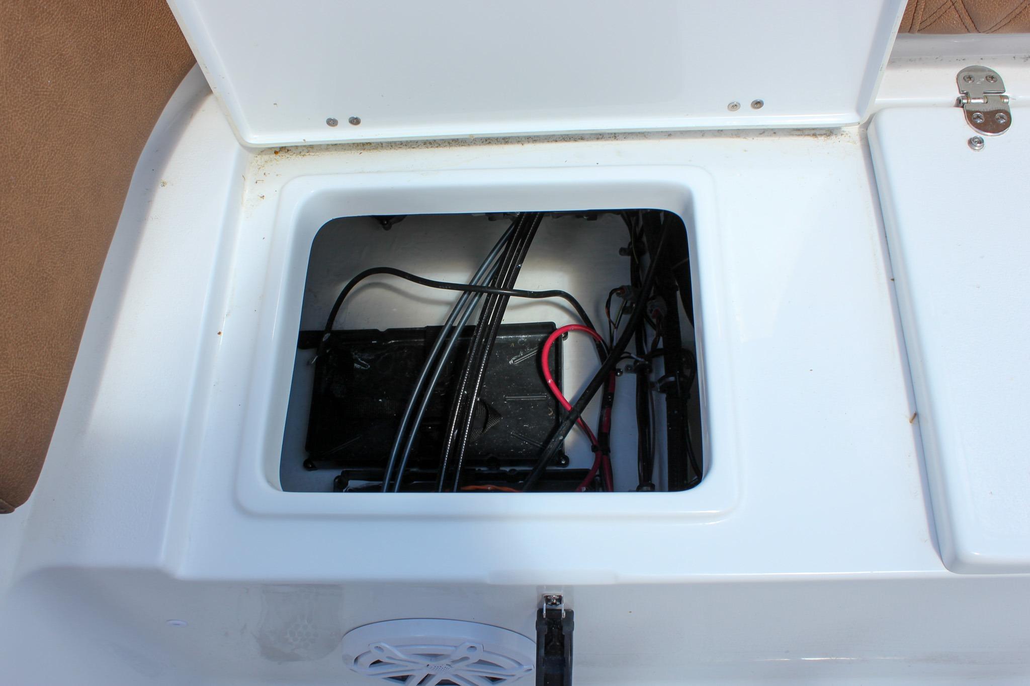 Battery compartment of 2027 Sea Hunt Ultra 234 boat with wiring visible.