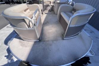 2012 Avalon Tahoe boat interior with beige seating and spacious deck.
