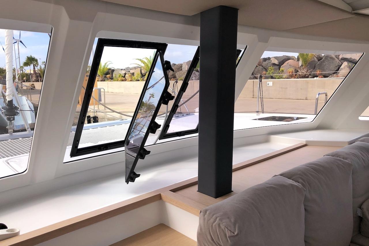 Interior view of 2018 Fountaine Pajot Lucia 40 catamaran with open windows and comfortable seating.