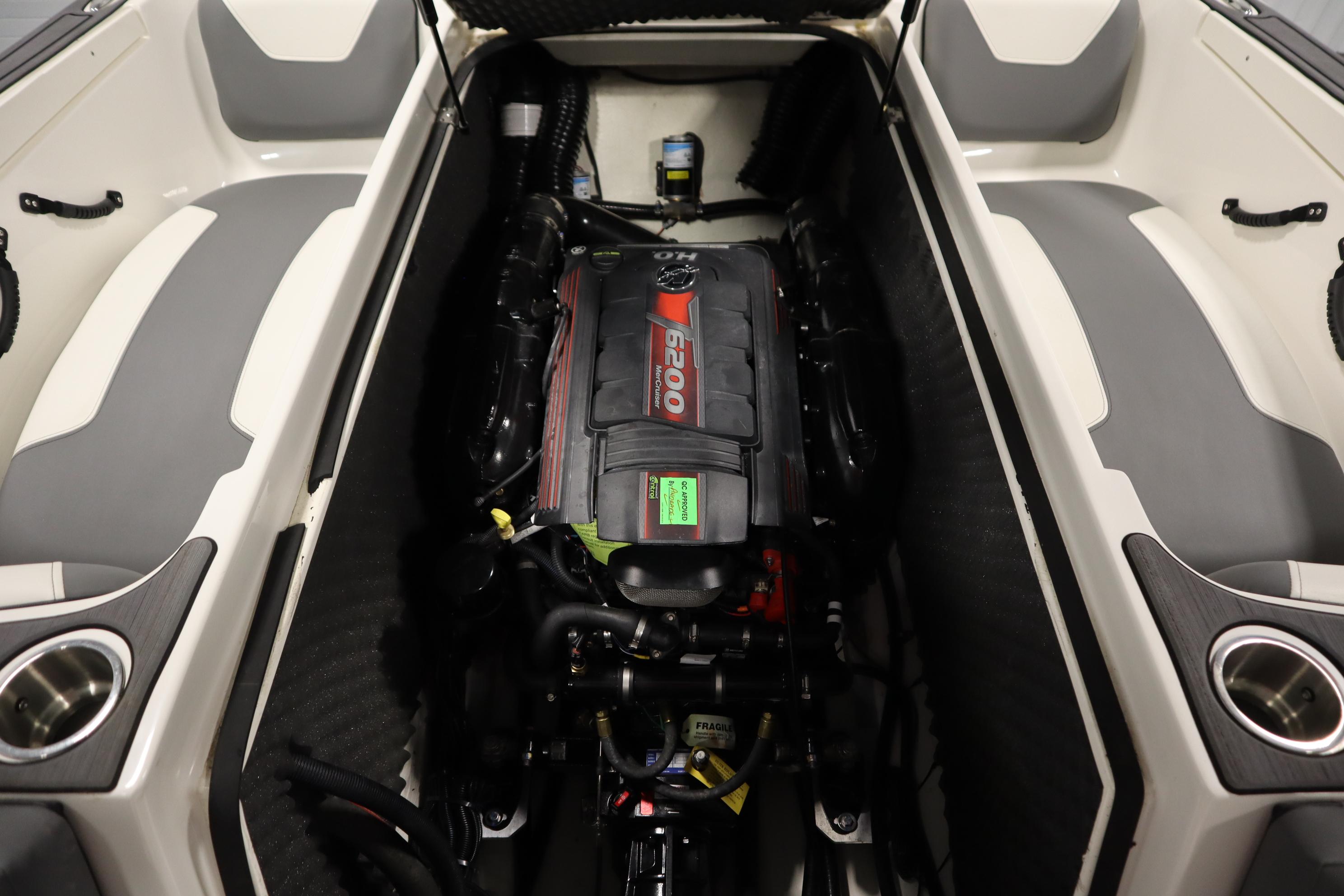 2023 Heyday WT Surf boat engine compartment with seating and cup holders.