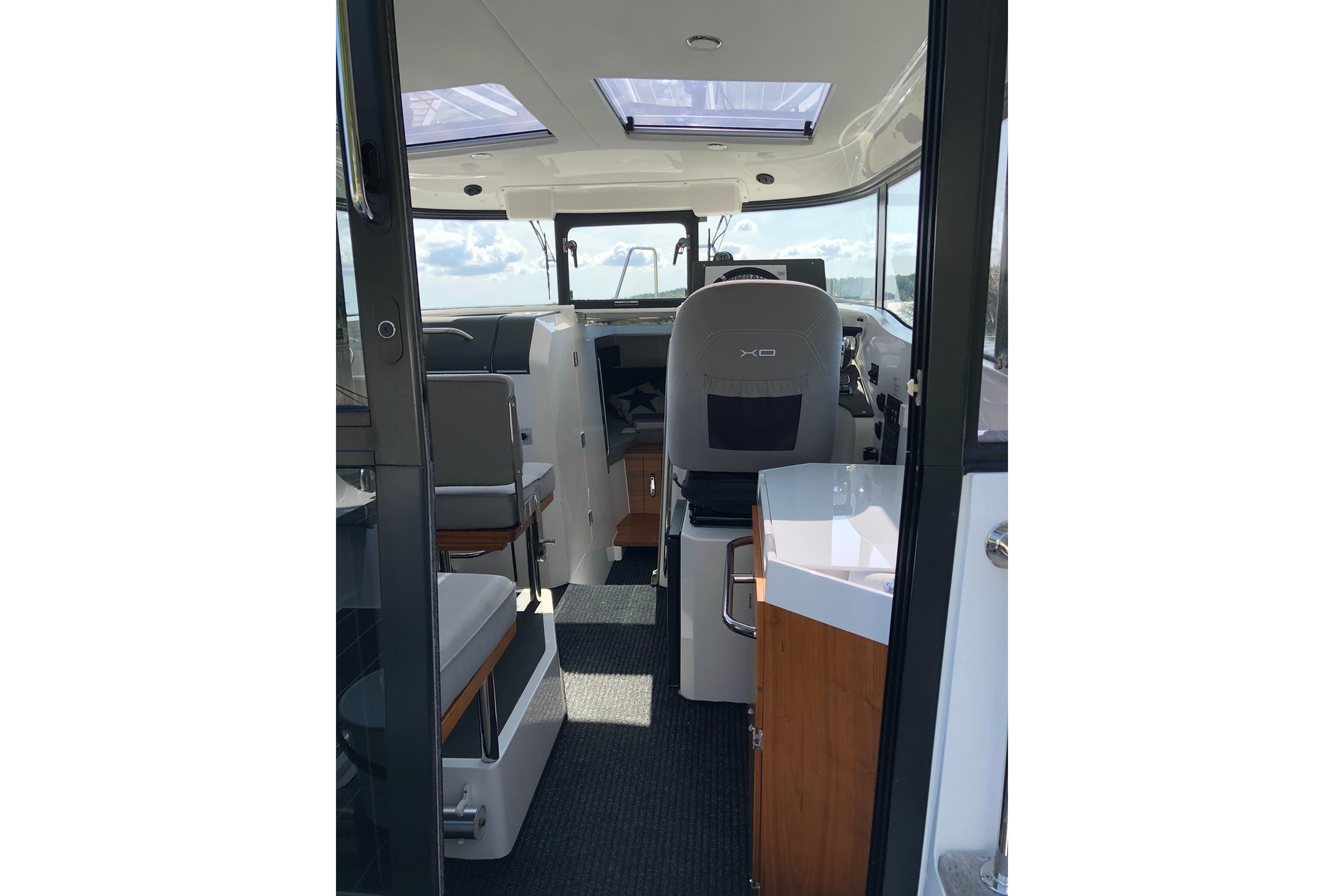 Interior of 2016 XO Boats 270 RS, featuring modern seating and helm area.