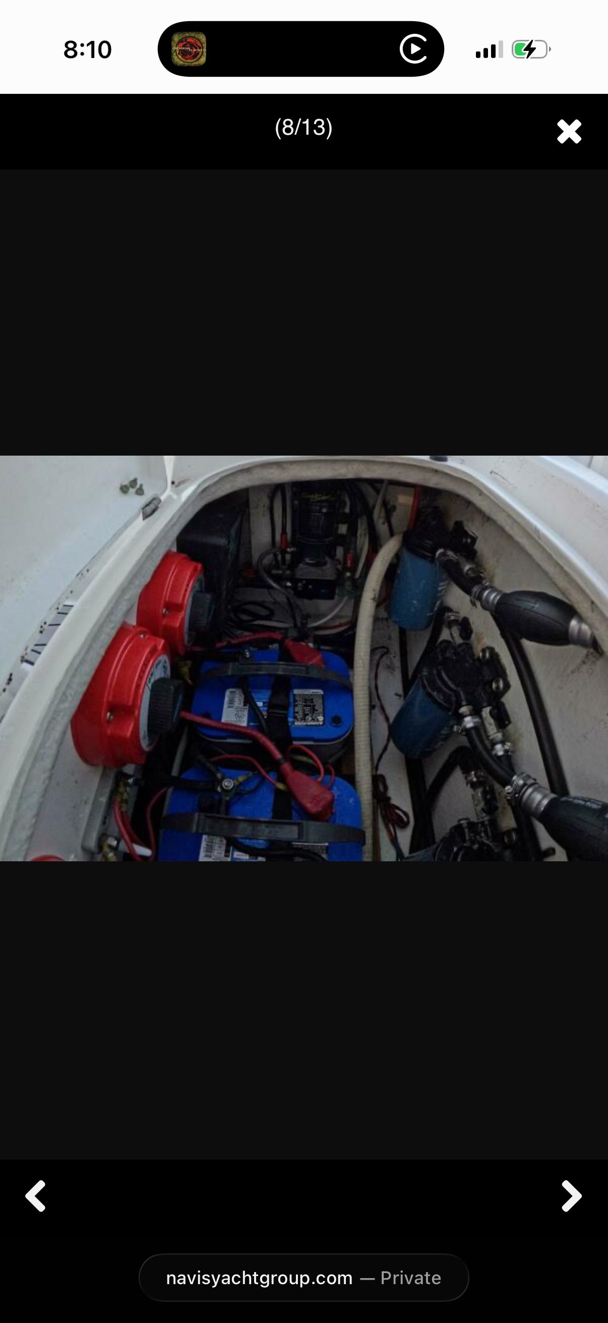 View of a boat's engine compartment with batteries and cables.
