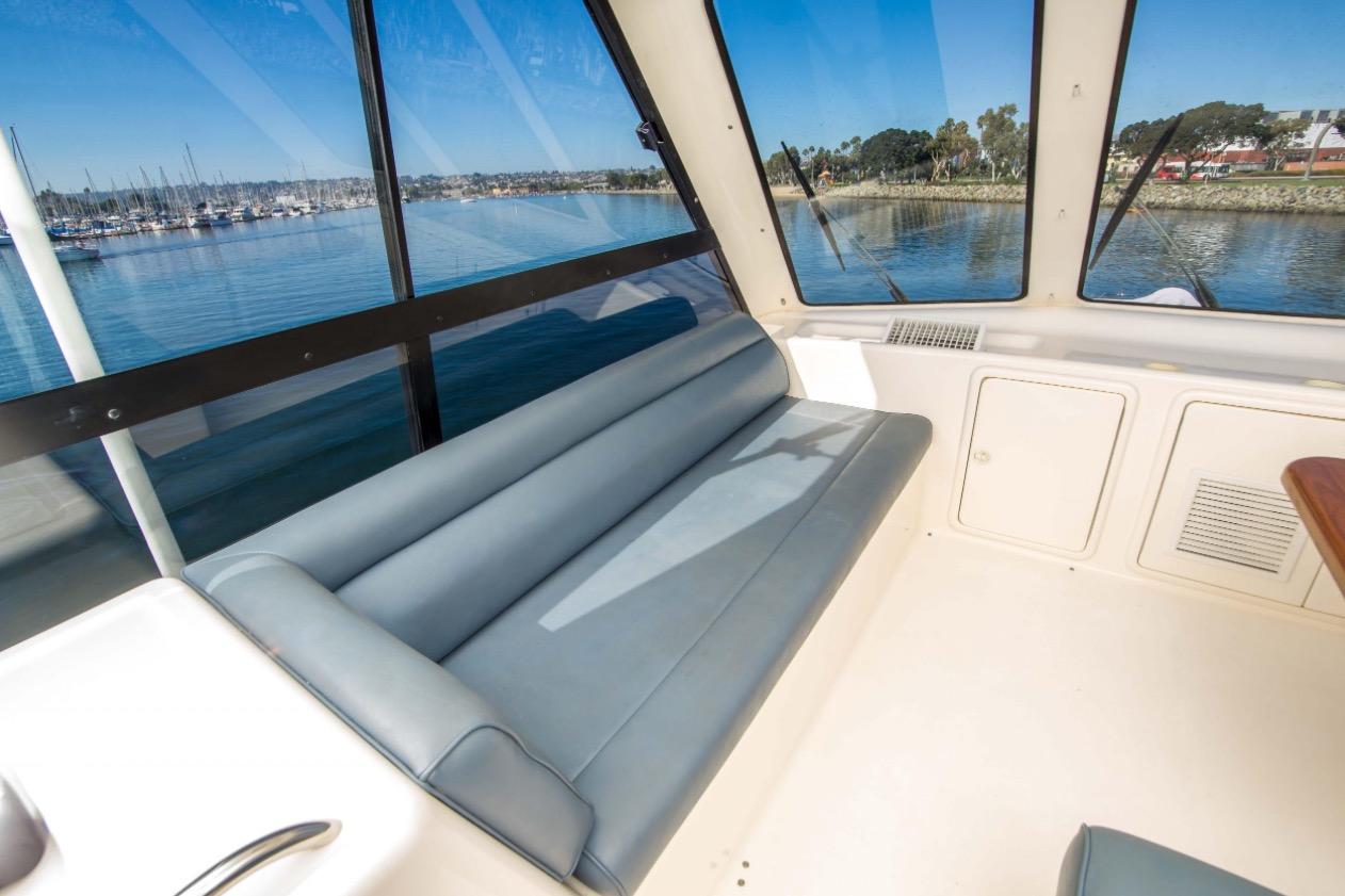 Interior of 2000 Riviera 48 Enclosed Flybridge with scenic marina view.