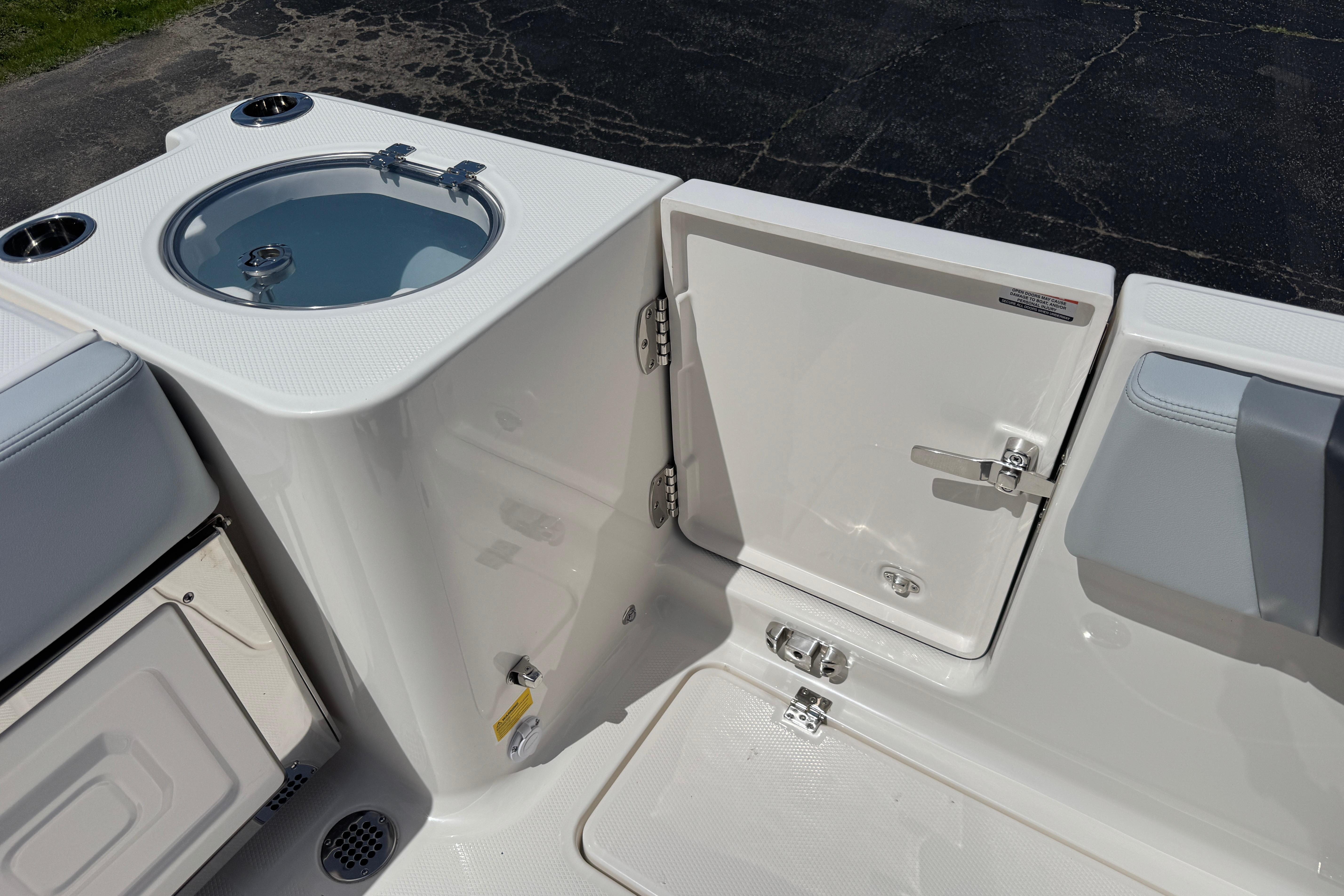 2026 Robalo R250 Center Console boat with livewell and storage compartments.
