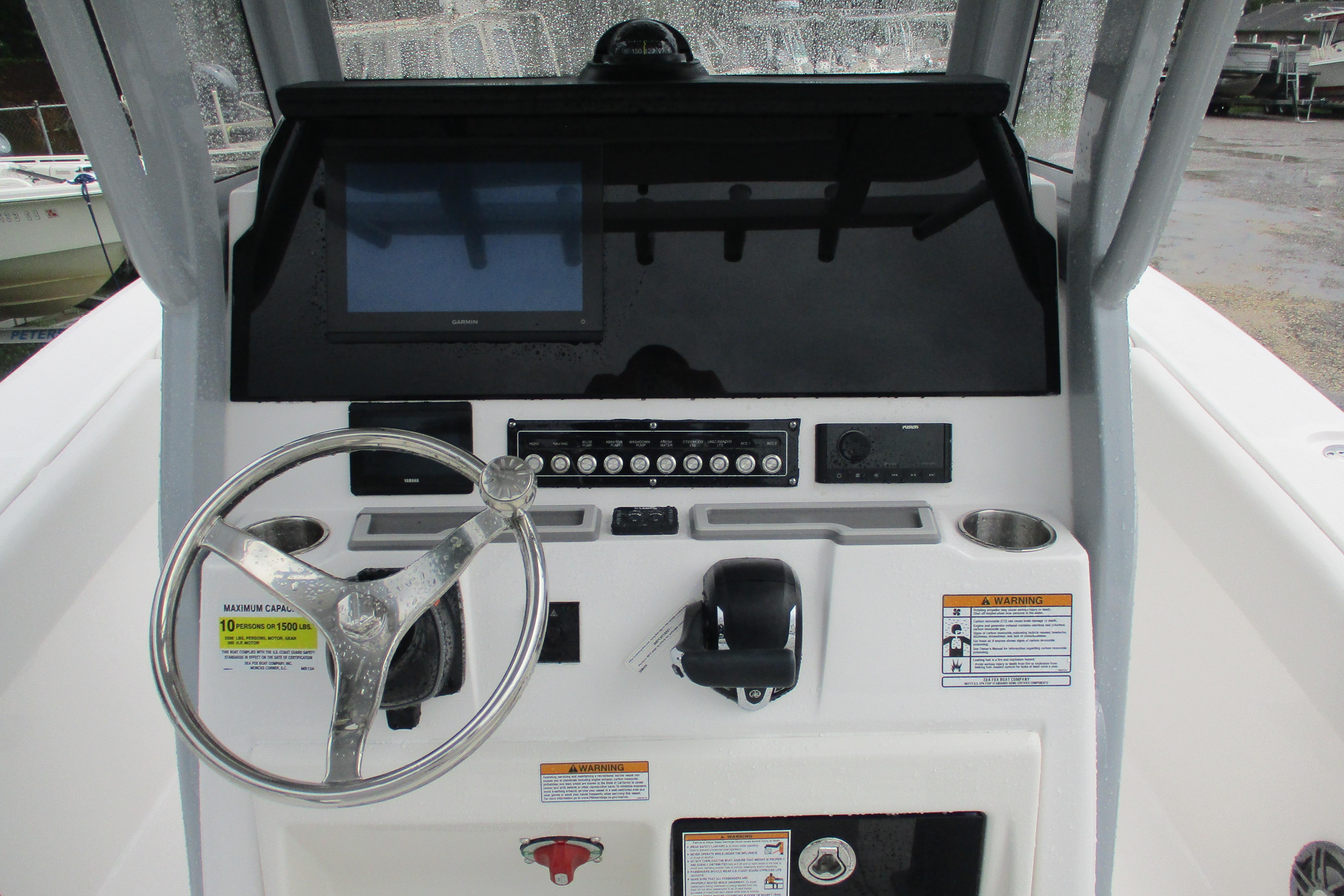 2026 Sea Fox 248 Commander boat dashboard with steering wheel and controls.