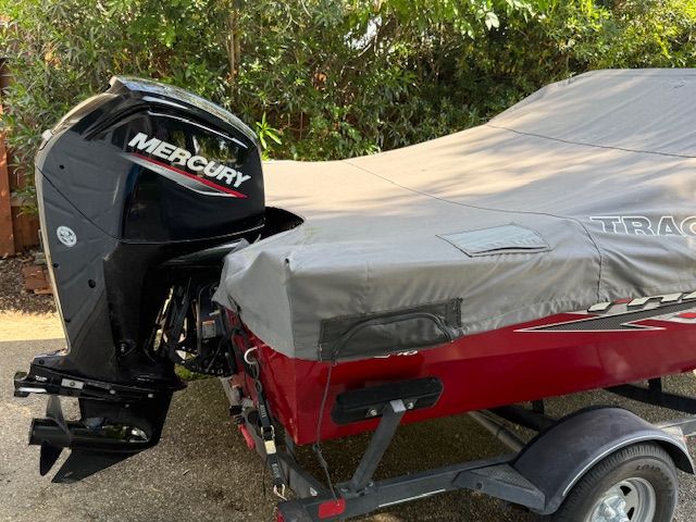 A 2023 Tracker PGV16WT 16 boat with a cover and a Mercury outboard motor.