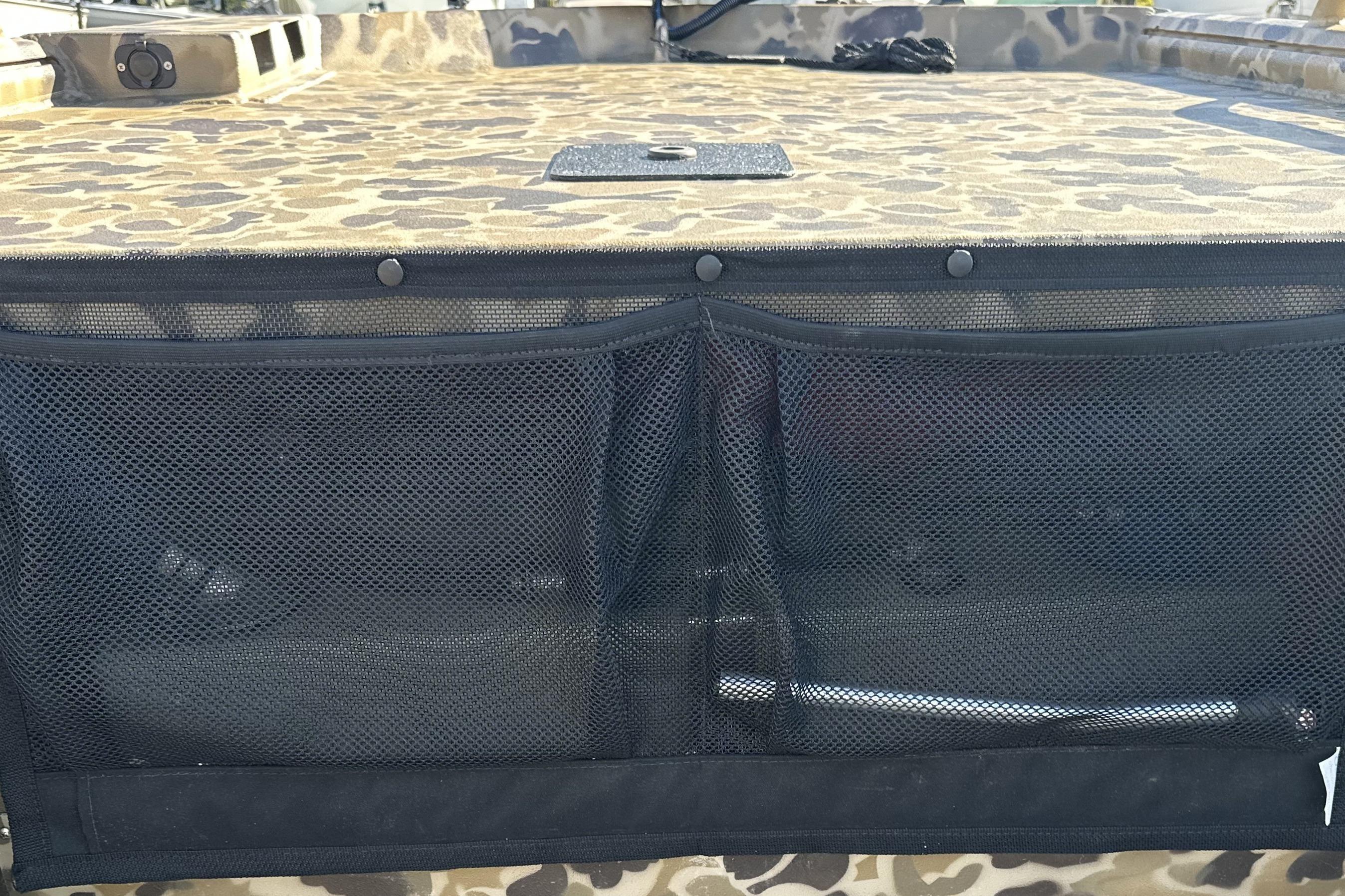 Camouflage-patterned deck of 2026 Excel 1751 Viper F4 boat with mesh storage pocket.