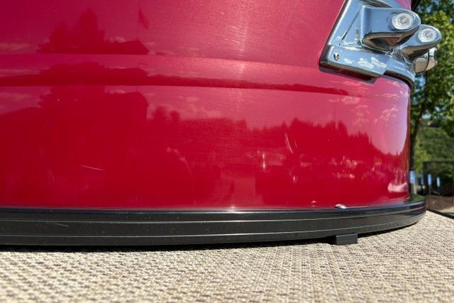 Close-up of a red 2025 Regency 250 DL3 boat exterior detail.