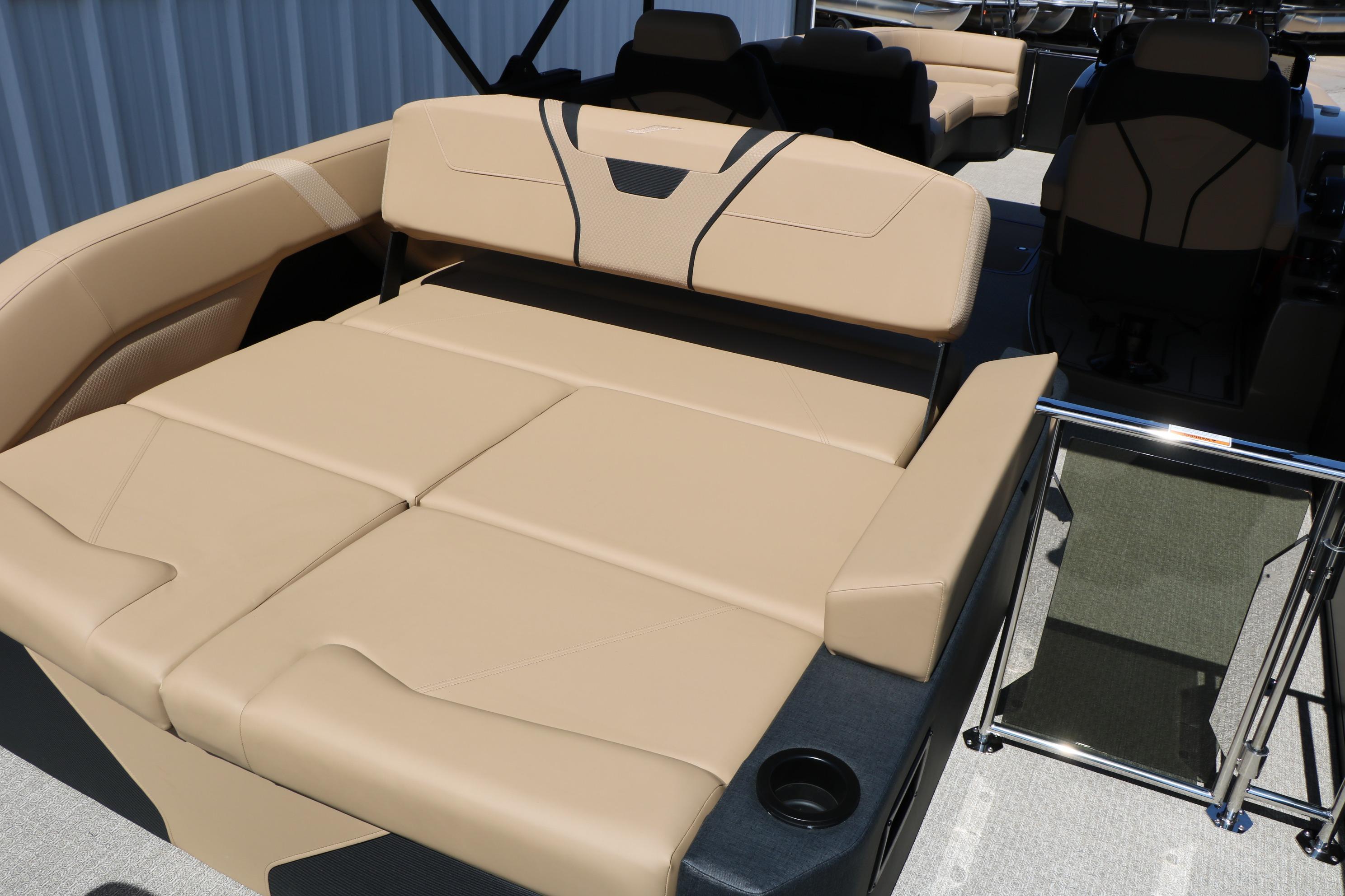 Luxurious seating on the 2026 Evotti 725 CS Tri-Toon boat, featuring beige upholstery.