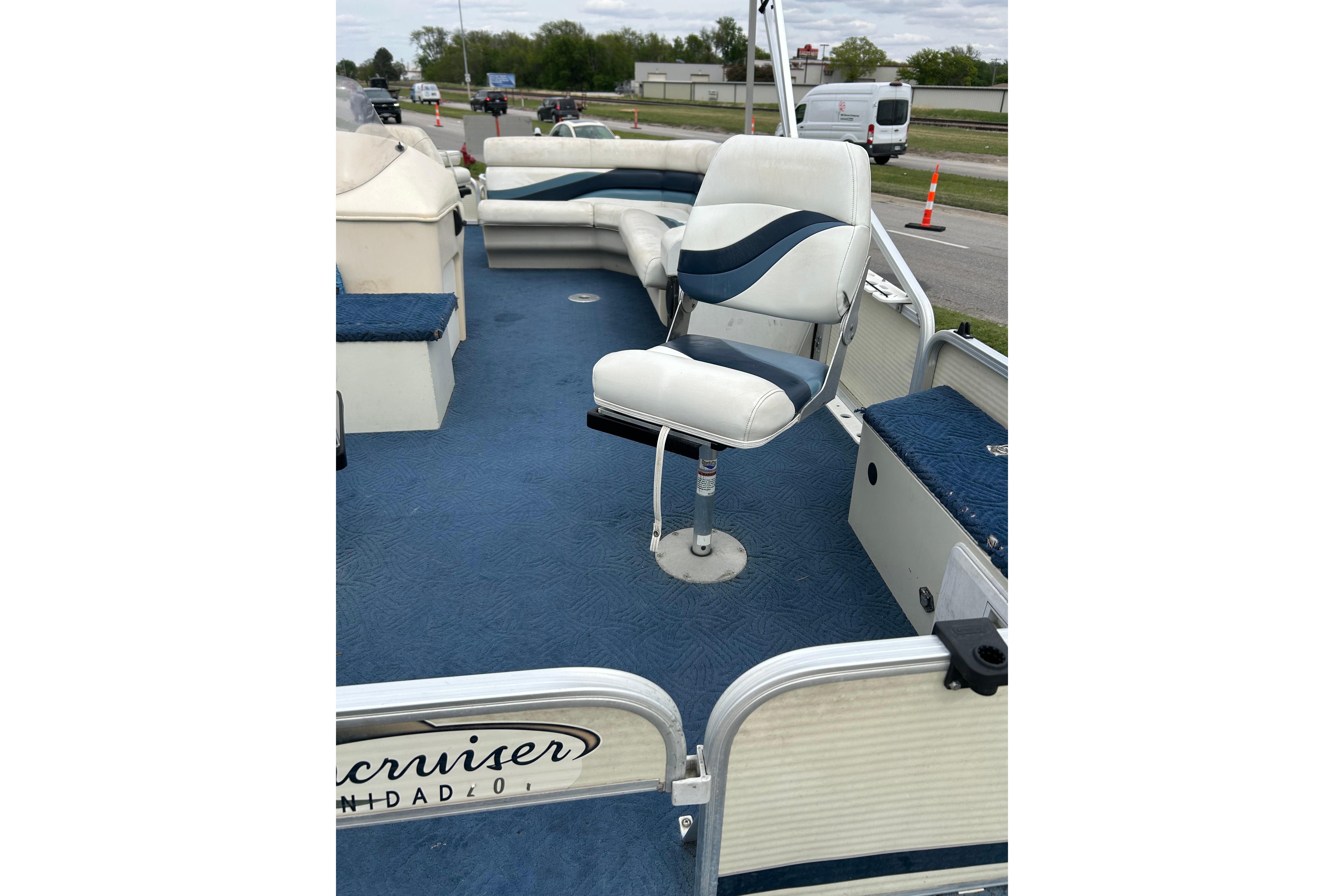 2002 Lowe Trinidad 200 pontoon boat interior with blue and white seating.