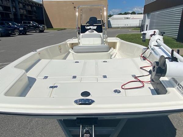 2024 Mako Pro Skiff 15 CC boat in a parking lot, featuring a spacious deck.