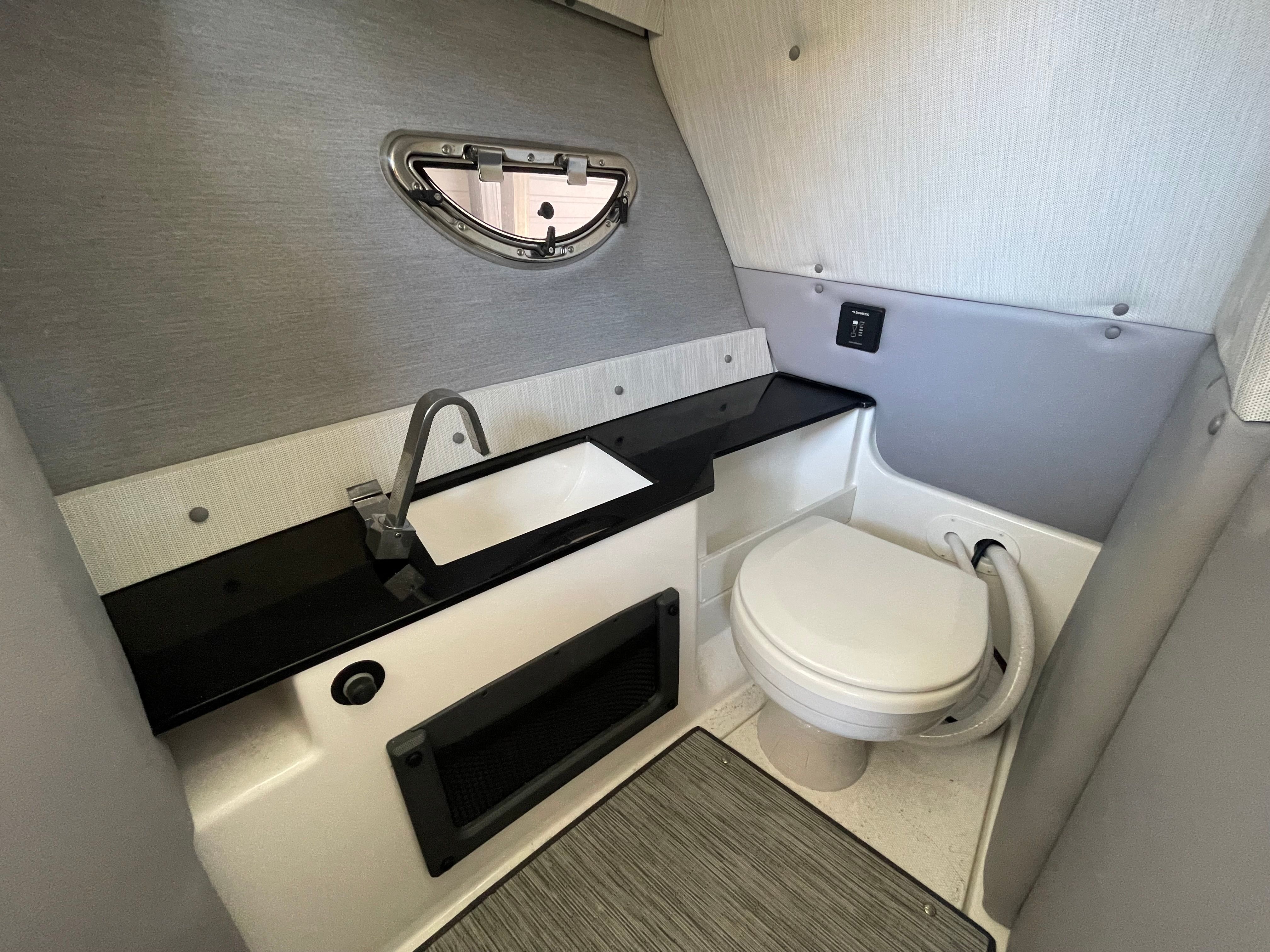 Interior of 2022 Cobalt R8 Outboard featuring toilet and sink.