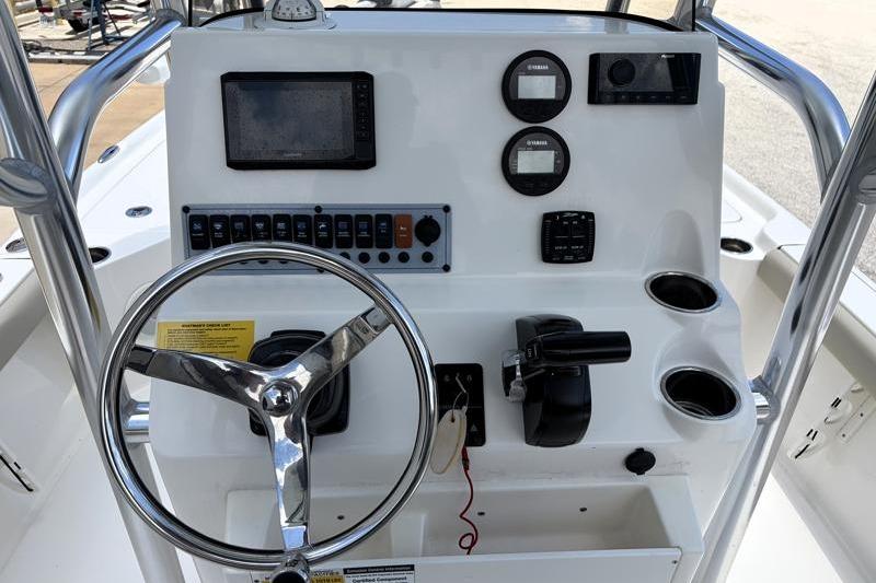 Center console of 2025 Key West 210 Bay Reef boat with steering wheel and controls.