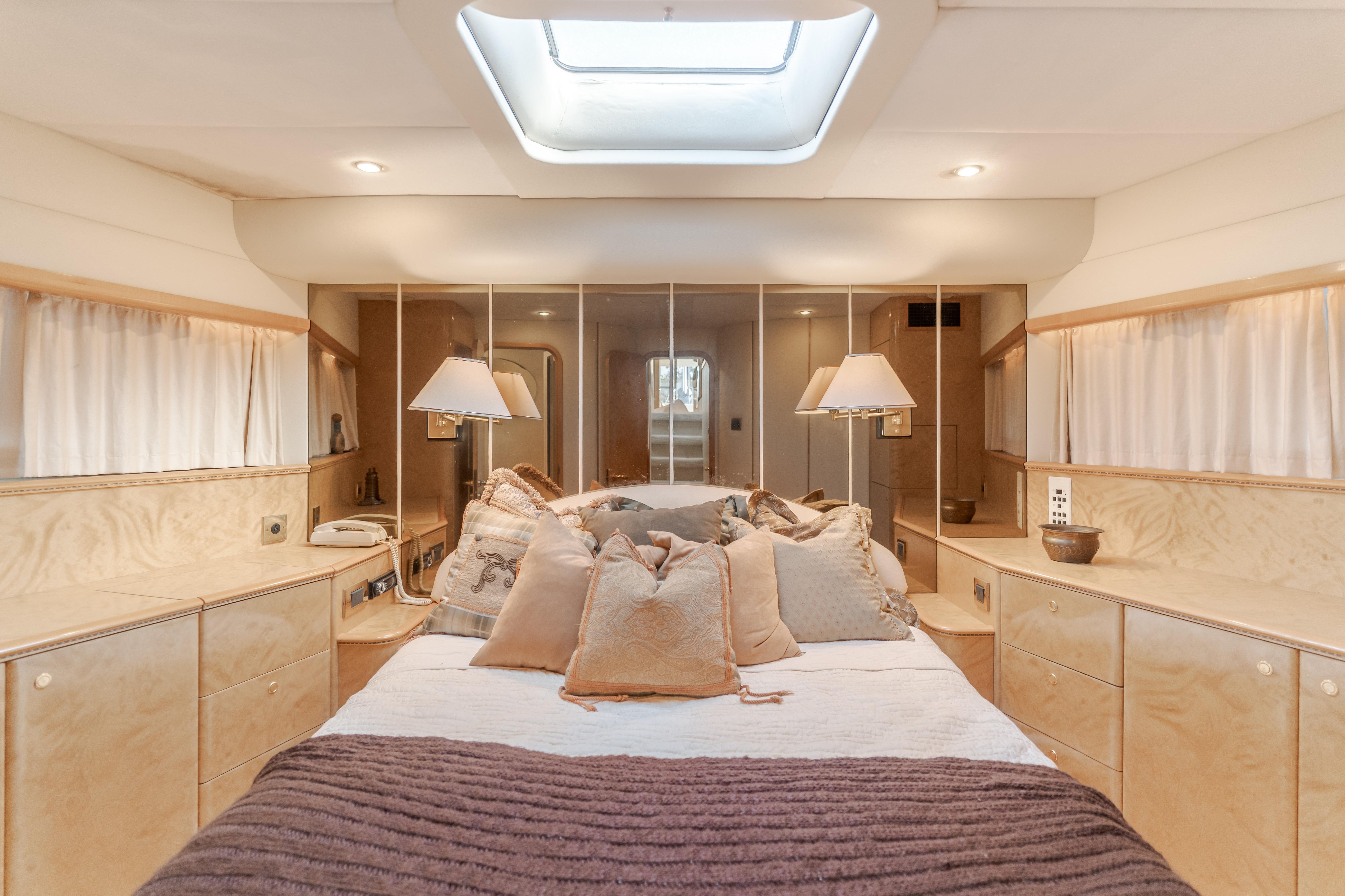 Luxurious bedroom interior of 1997 Viking Sport Cruisers 66 Motor Yacht with elegant decor.