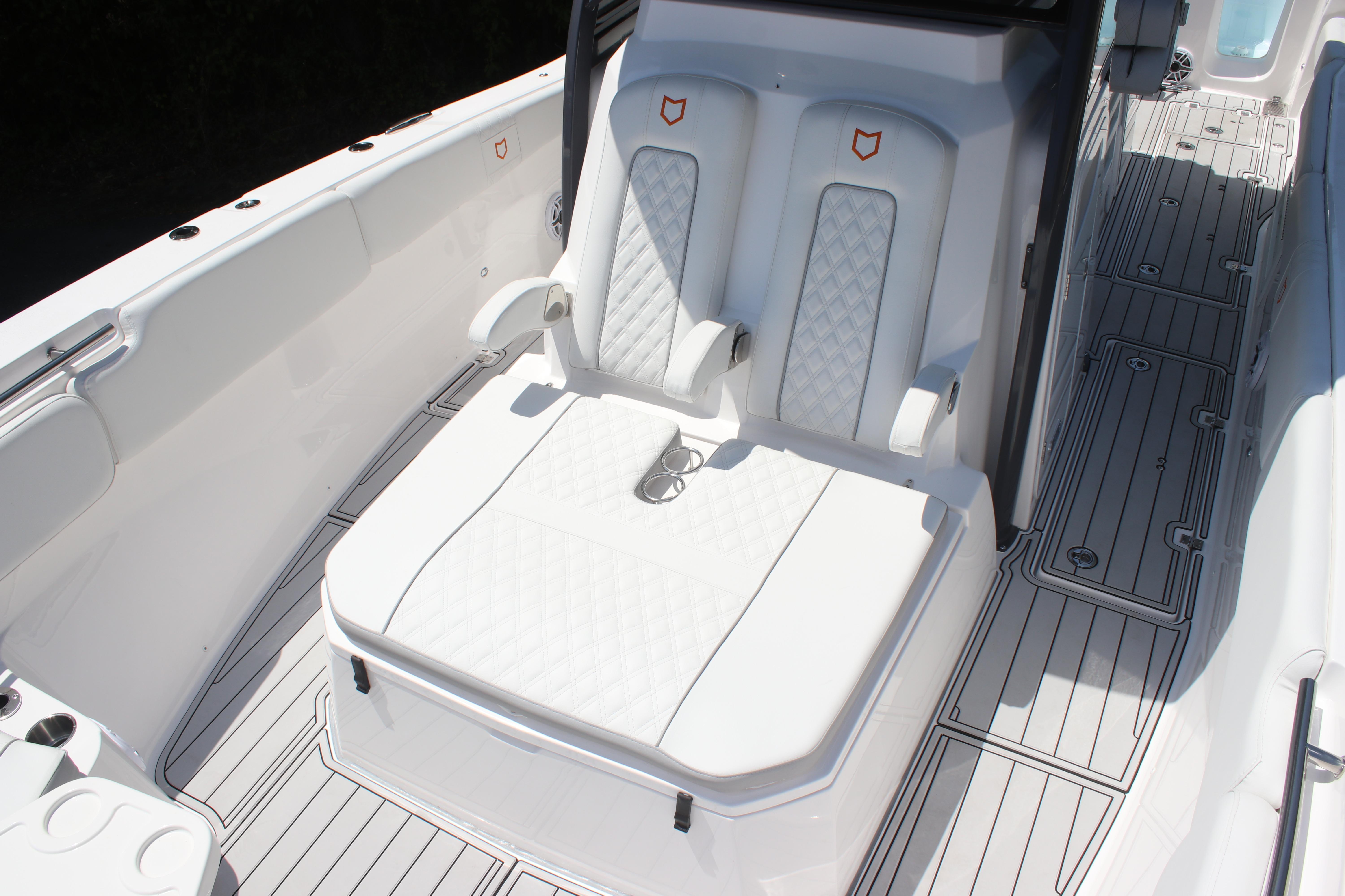 2025 Sea Fox 328 Commander boat interior with white cushioned seating and sleek deck design.