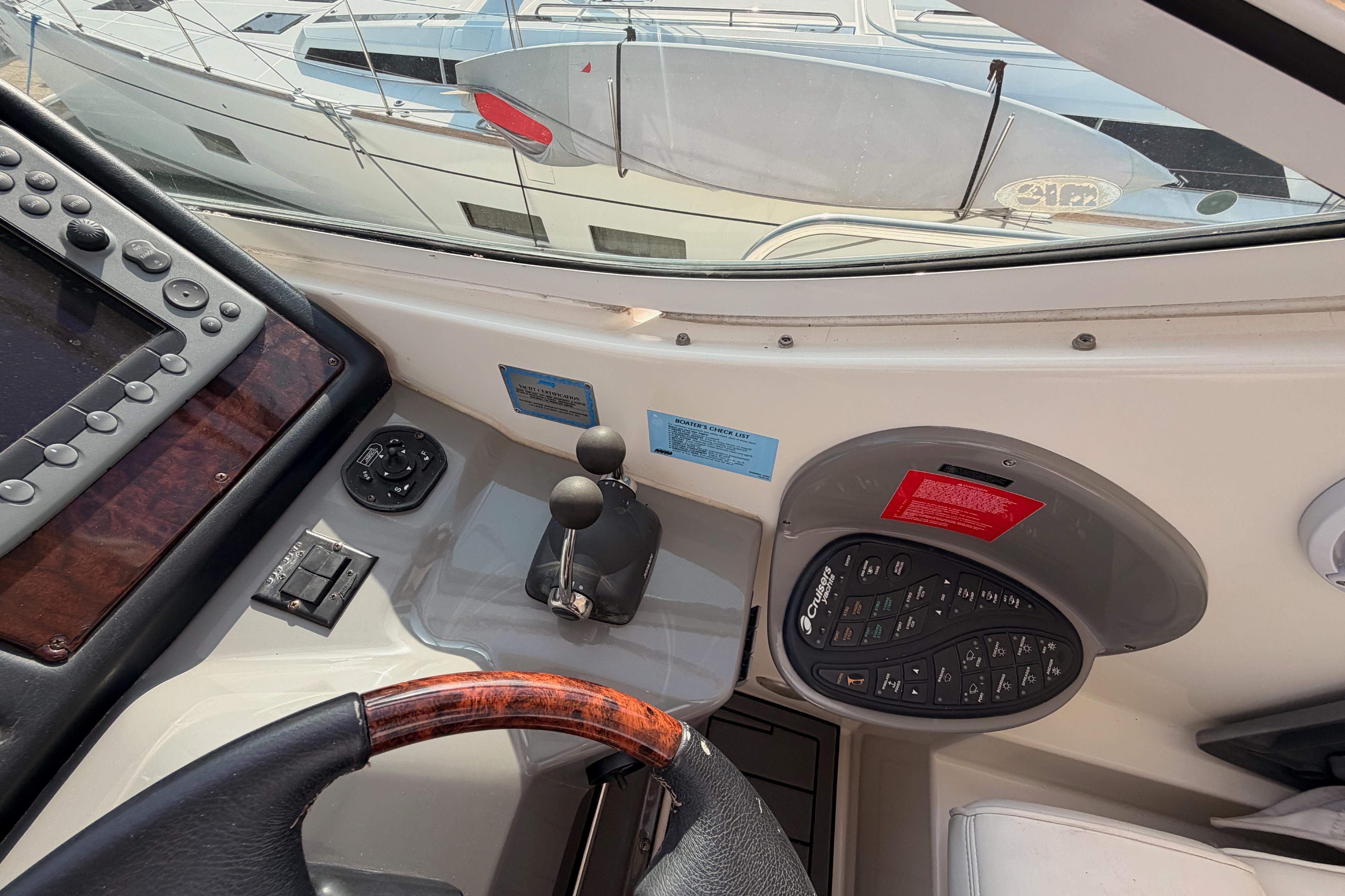2005 Cruisers Yachts 405 Express Motoryacht helm with controls and navigation equipment.
