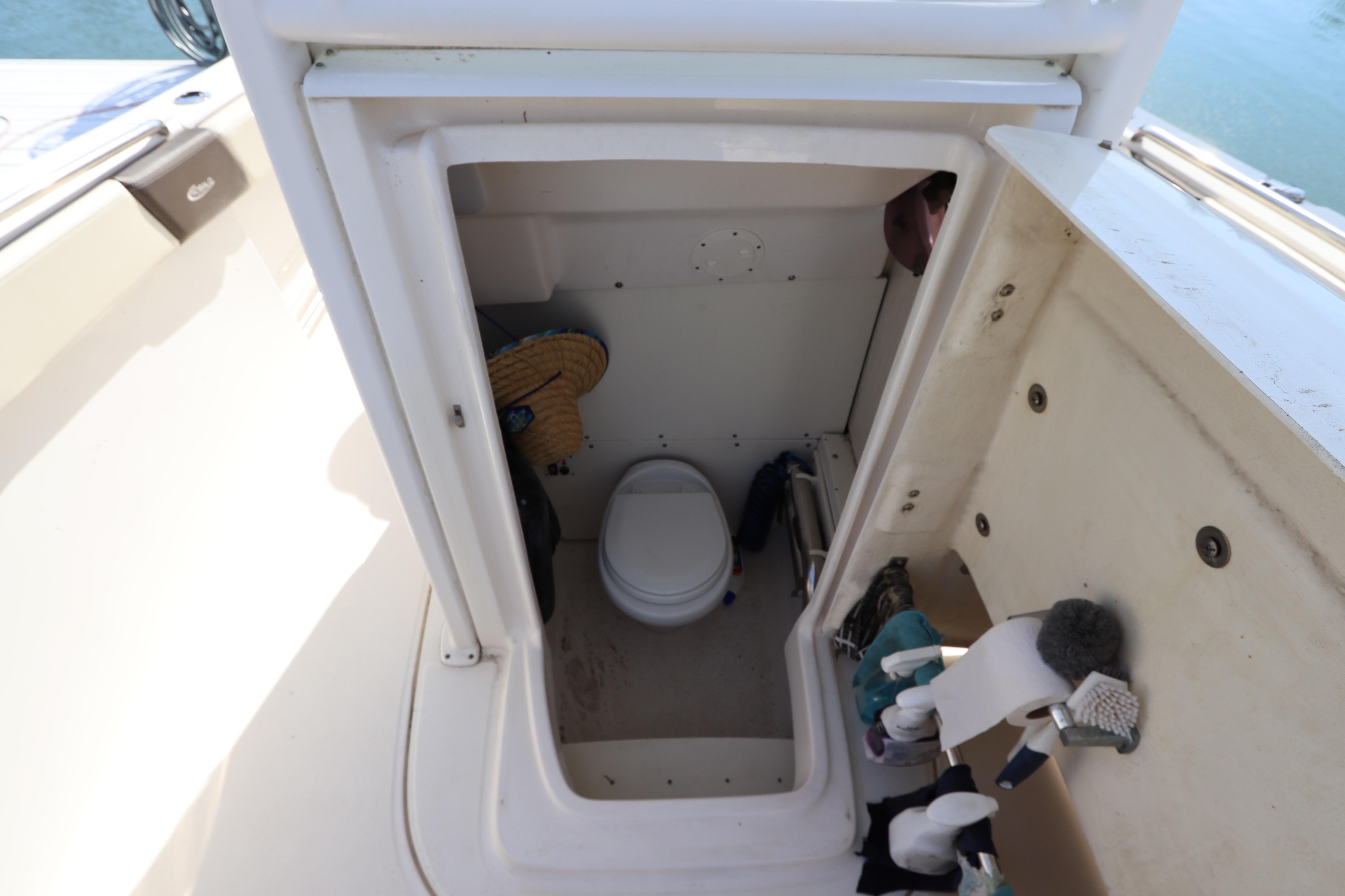 2019 Robalo R242 Center Console boat interior with compact marine toilet.
