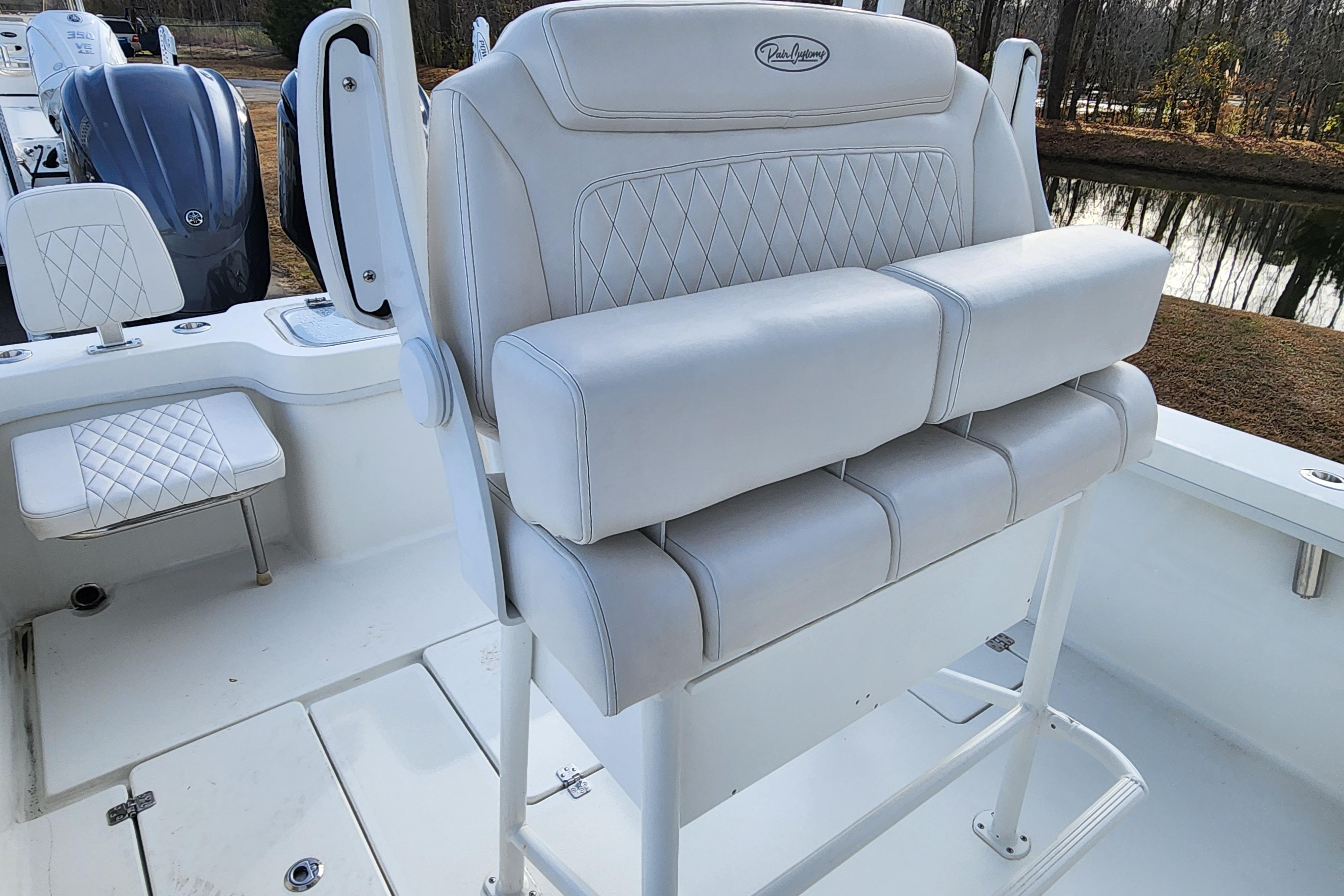 2024 Pair Customs 27 CC boat with luxurious white seating and dual outboard engines.